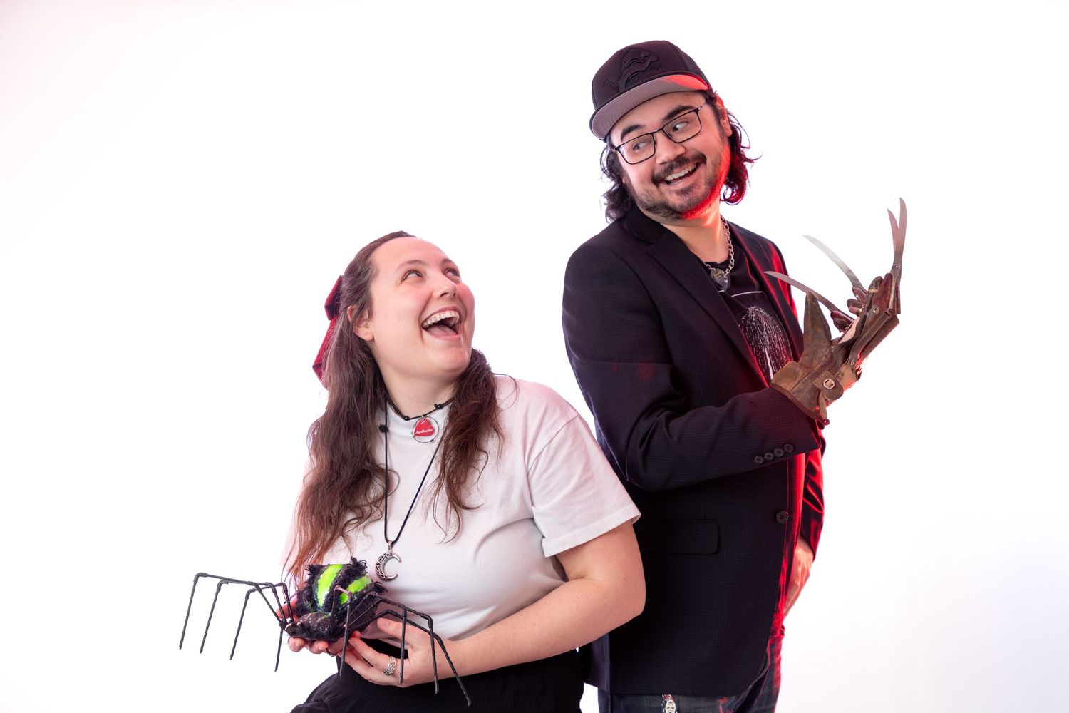 Studio photoshoot with playful poses against white background.