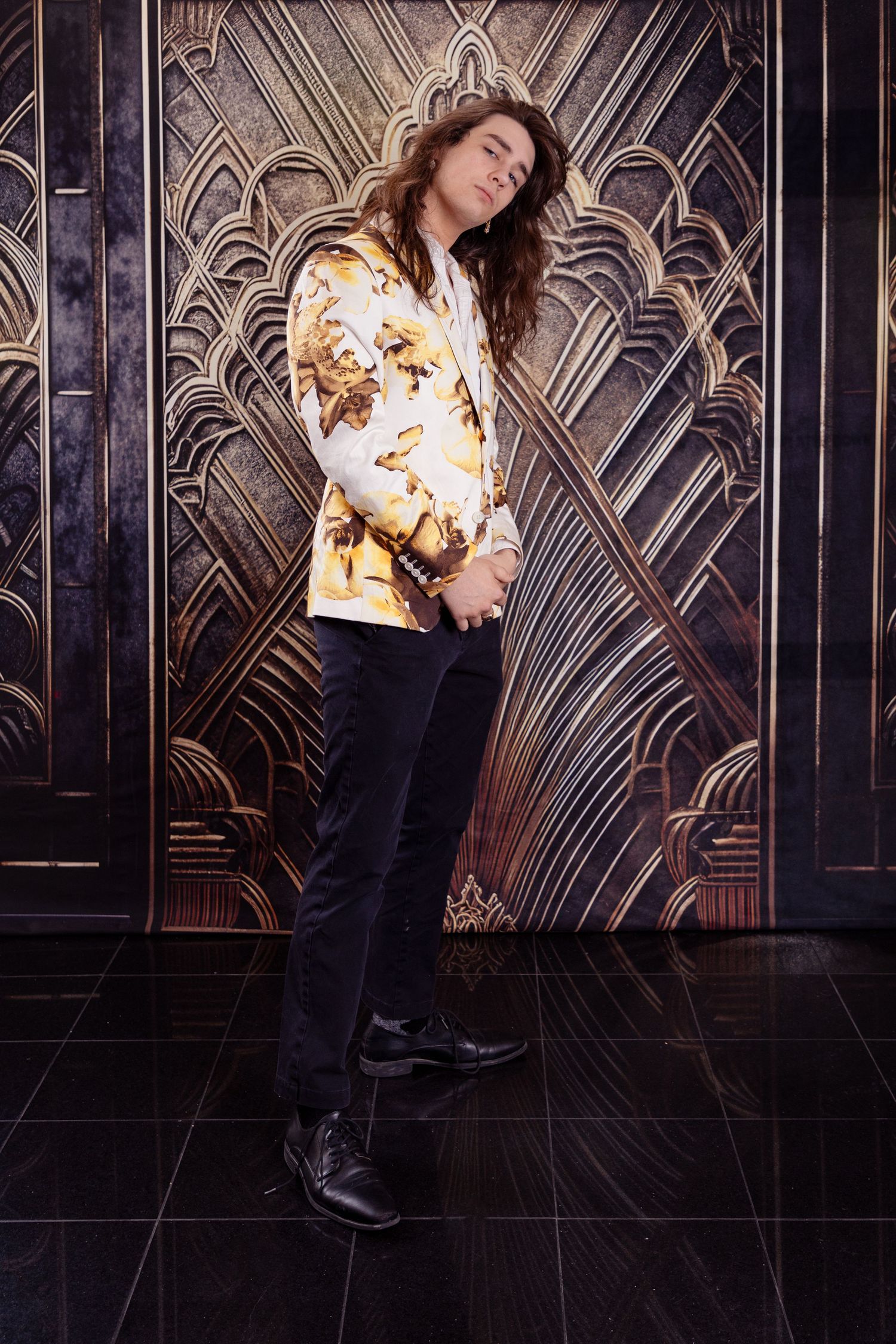 Fashion portraits with a floral print top against a dark geometric background.