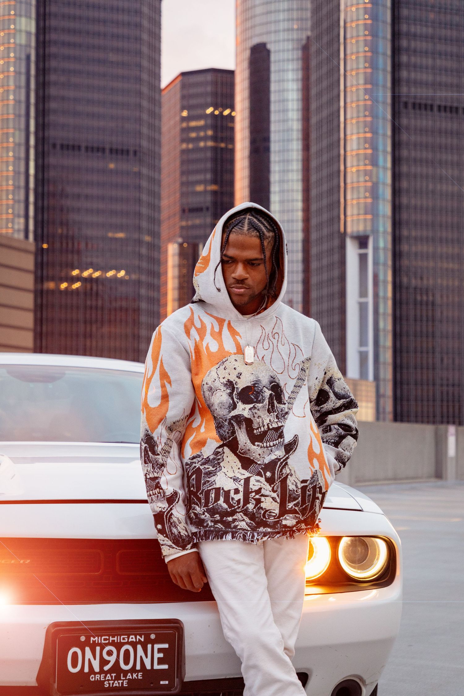 A street style photo featuring a skull-print hoodie against Detroit's Renaissance Center backdrop.