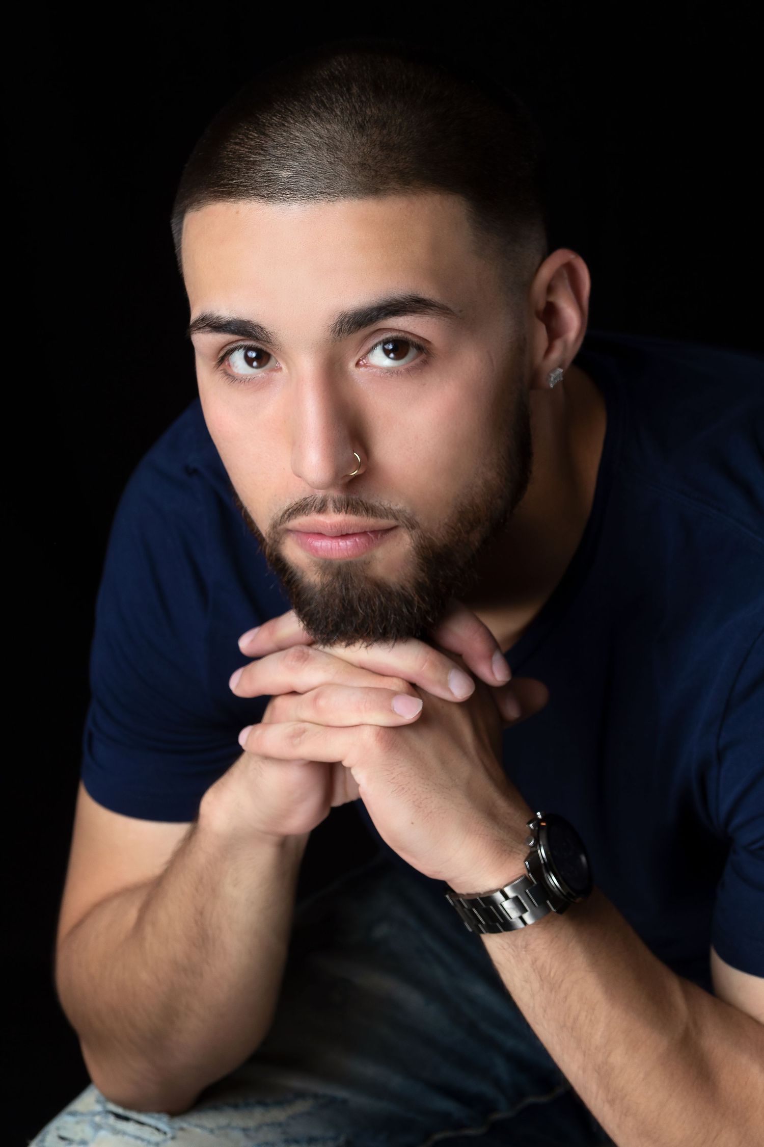 Studio portrait series showing contemplative expressions against dark background.