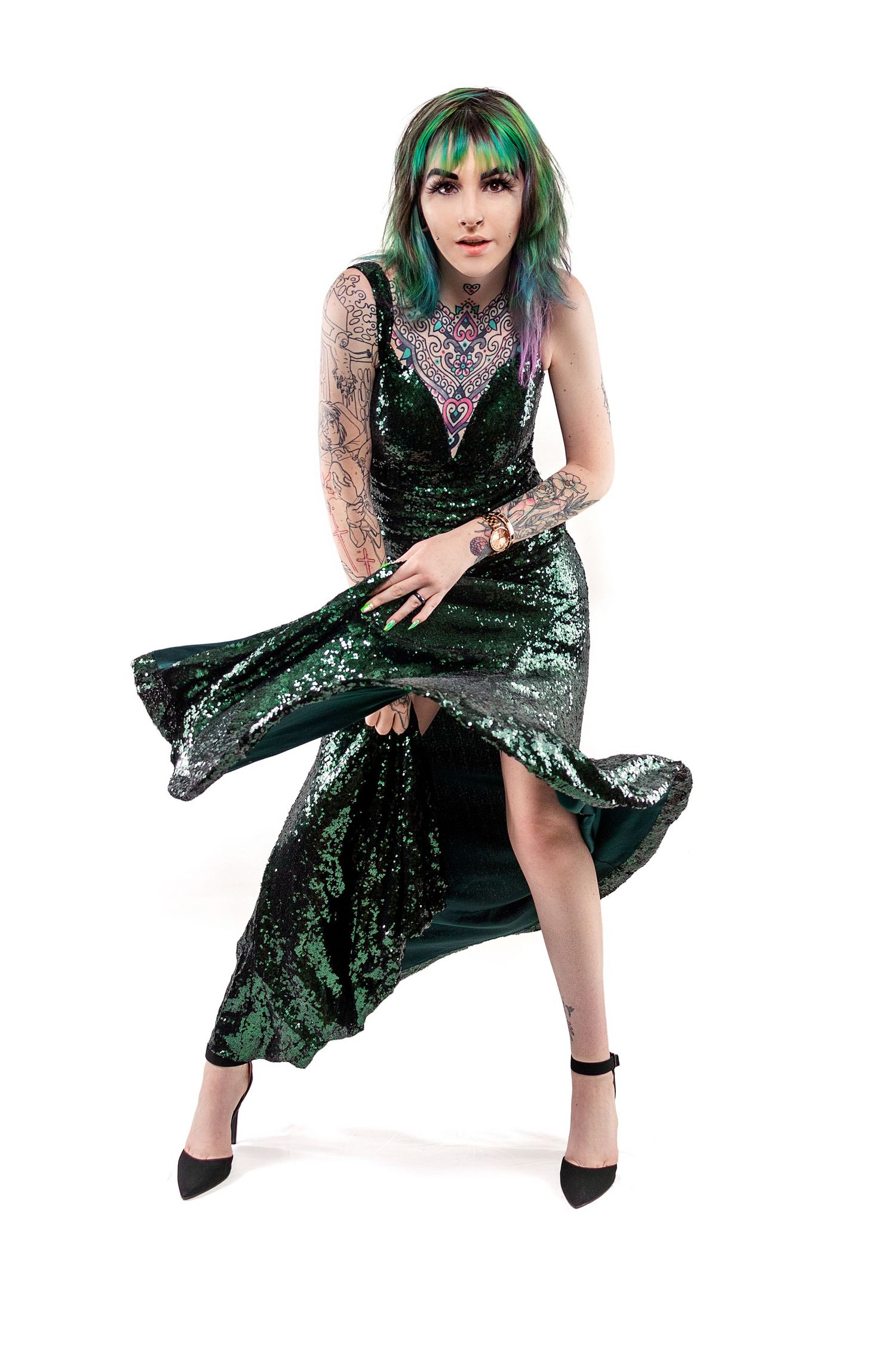 Fashion series showcasing flowing green sequin dress with dramatic movement and poses.