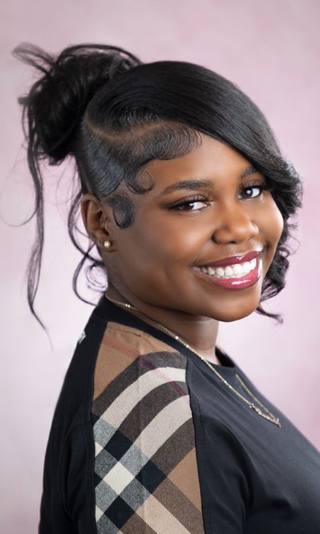 Stylish portrait series with someone wearing a plaid accent scarf against a pink backdrop.