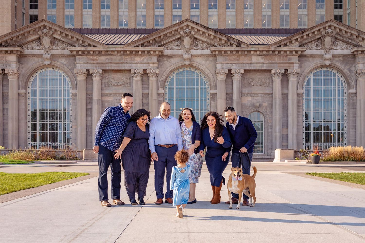Group photos taken in front of an ornate historic building with classical architecture.
