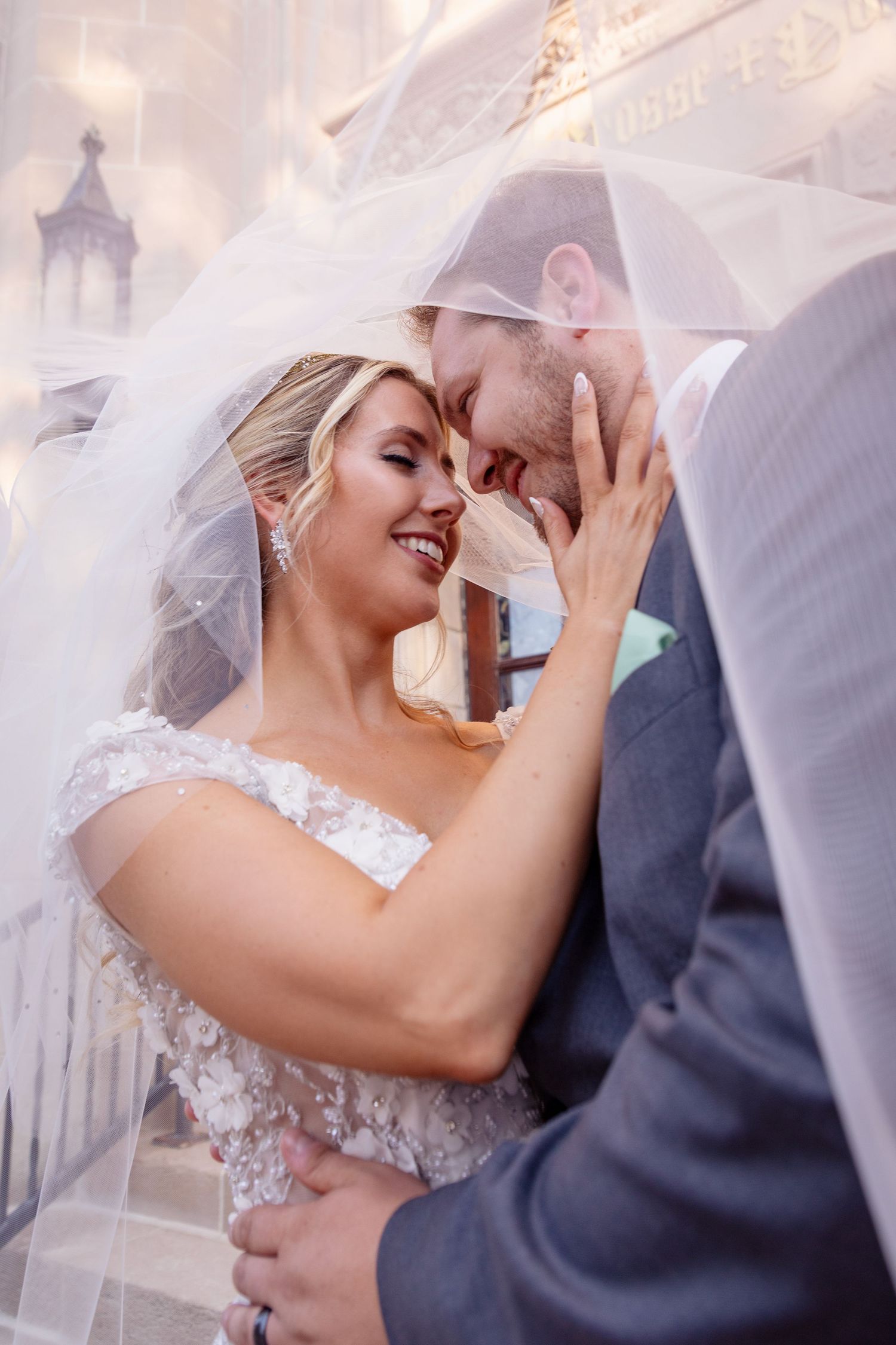 Intimate wedding portraits with couple sharing romantic moments under veil.