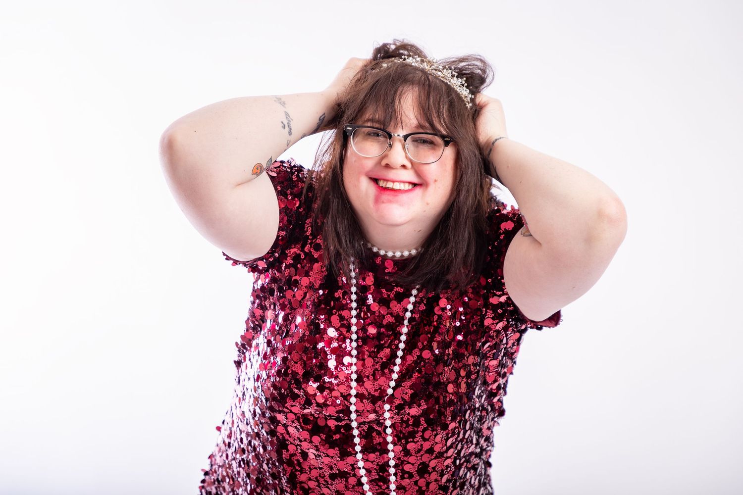 Portrait series featuring sparkly red sequined outfit against white background.