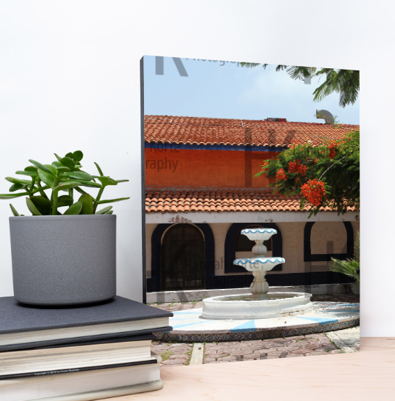 Modern outdoor courtyard with white stone fountains and terracotta roof tiles.