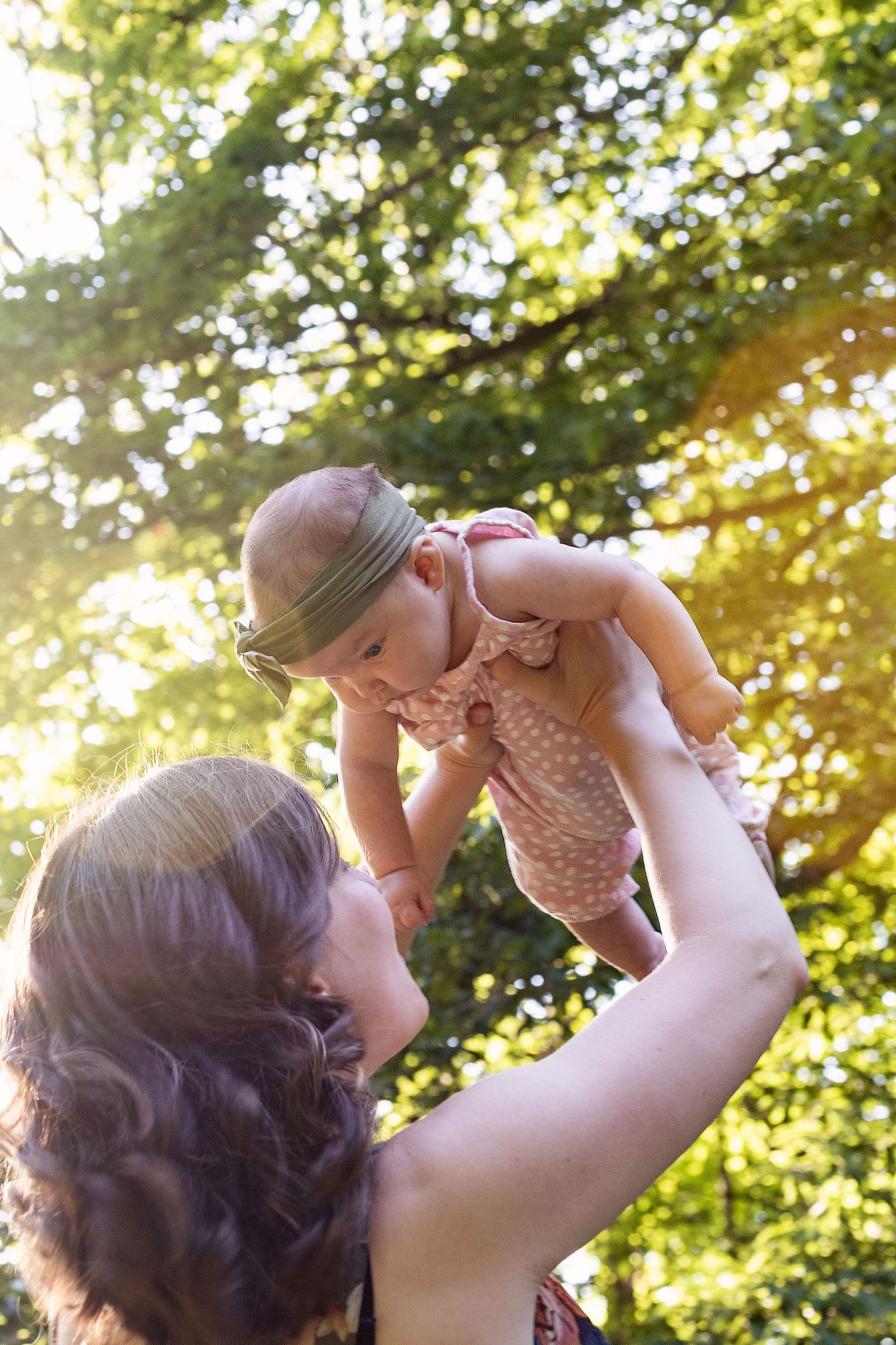 Joyful moments captured in golden sunlight through tree branches.
