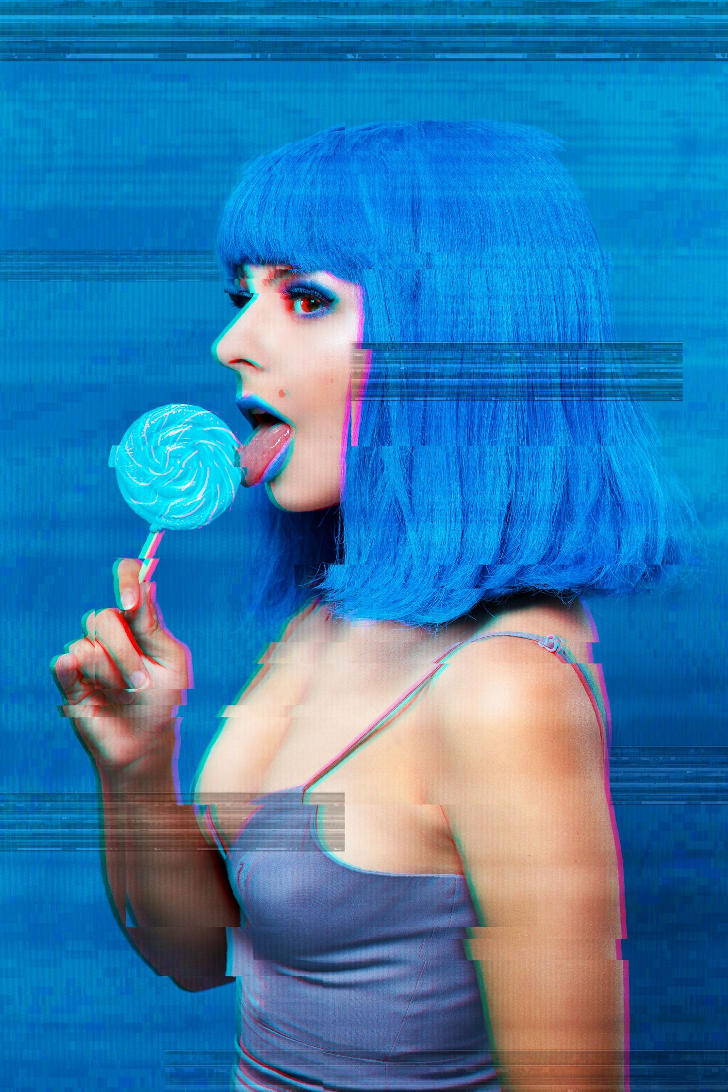 Figure with bright blue bob wig poses with matching blue lollipop against blue background.