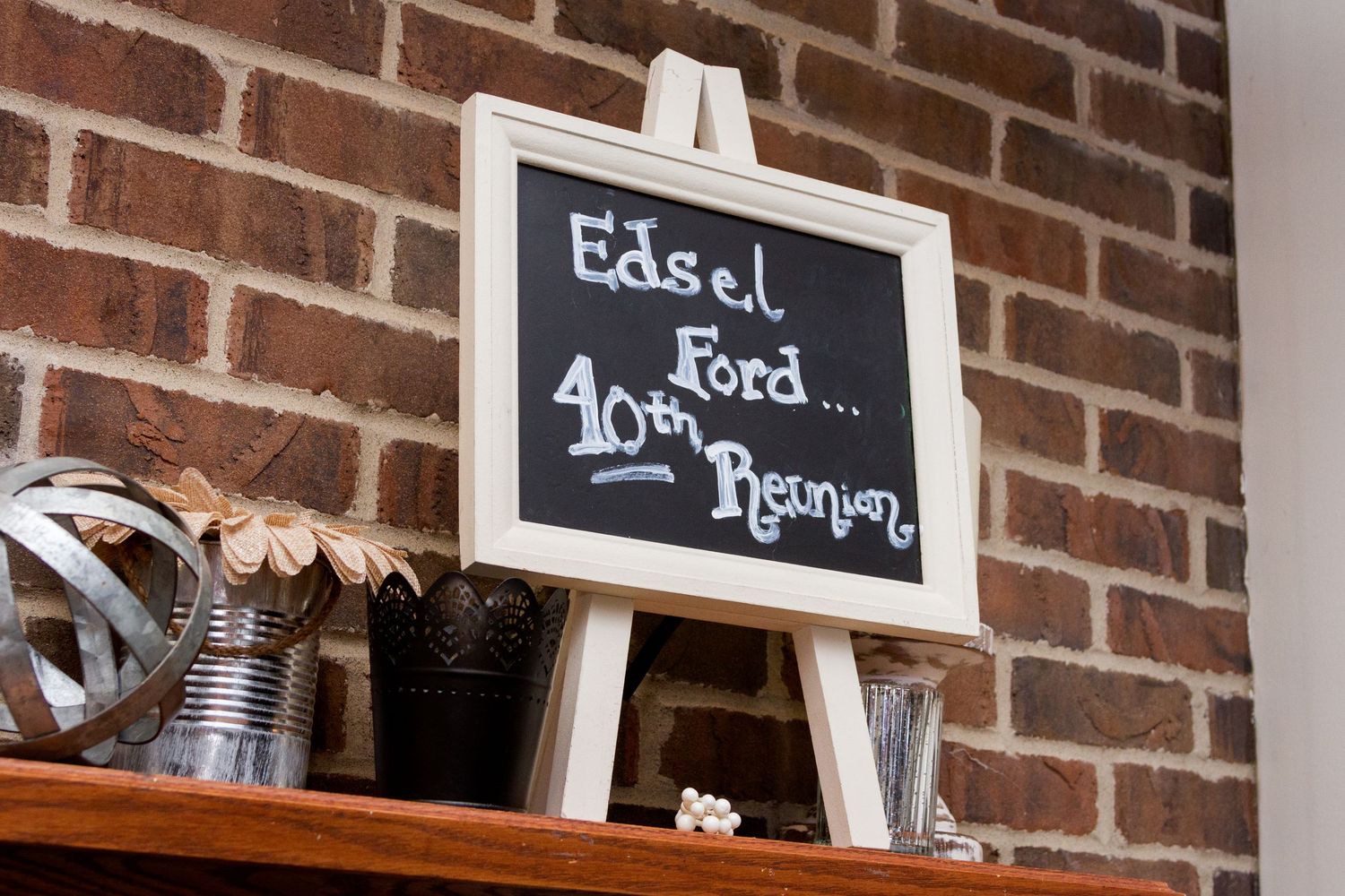 Rustic brick wall interior with chalkboard signs and vintage decor.
