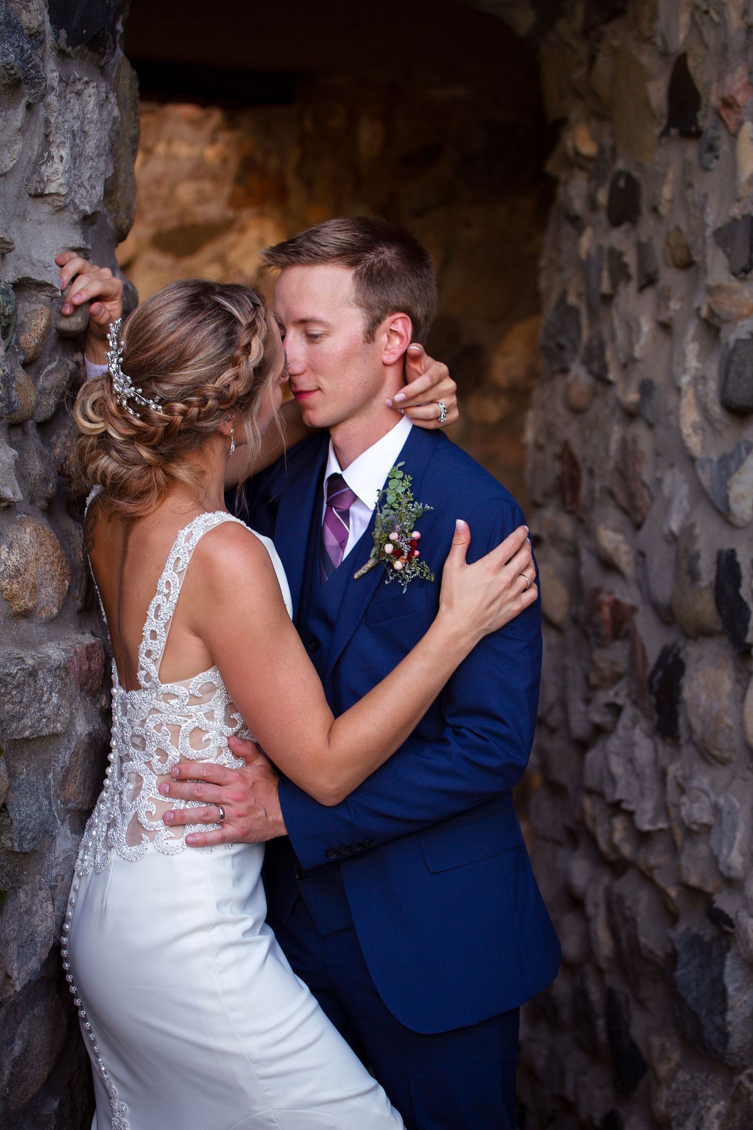 Intimate wedding portraits taken inside a stone tunnel or cave setting.