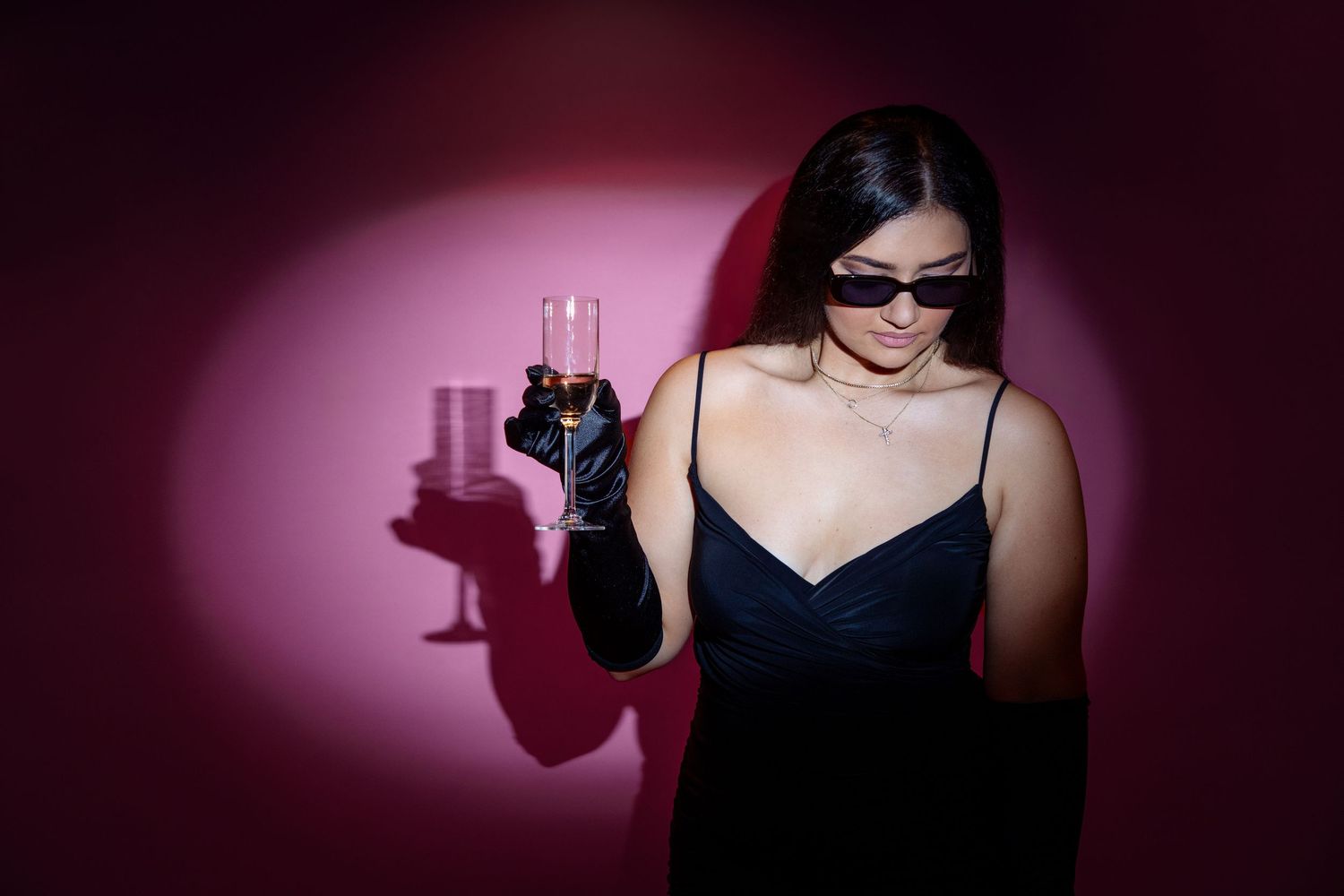 Artistic portrait series with dramatic lighting and props against burgundy background.