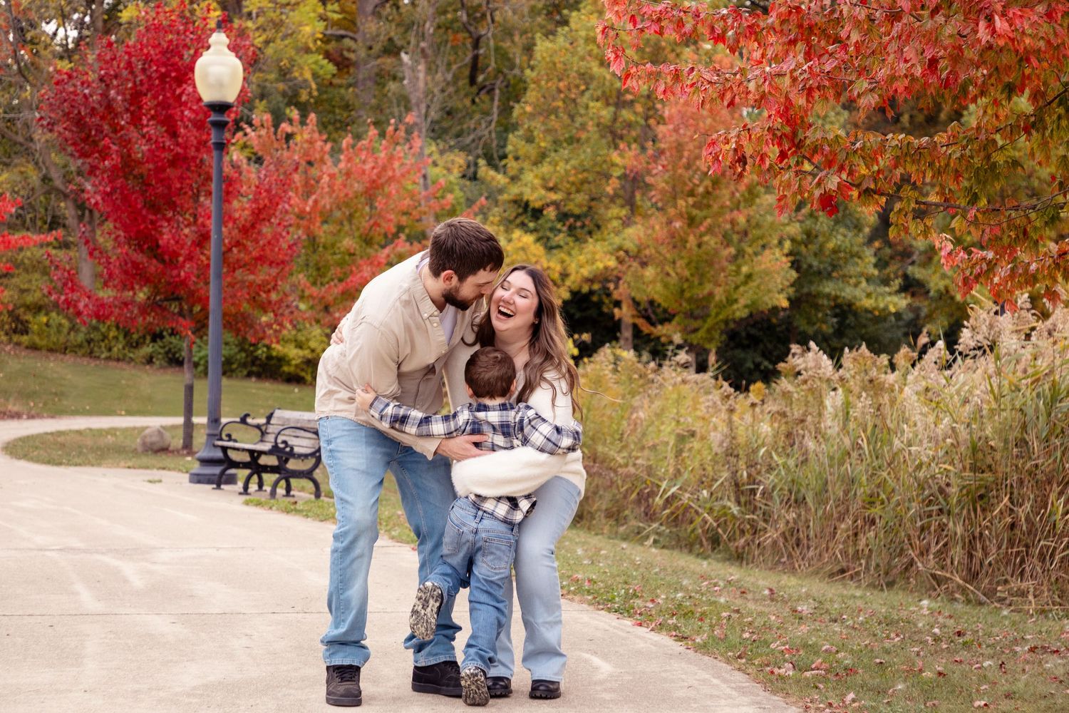 Fall foliage creates a colorful backdrop for outdoor family portraits.