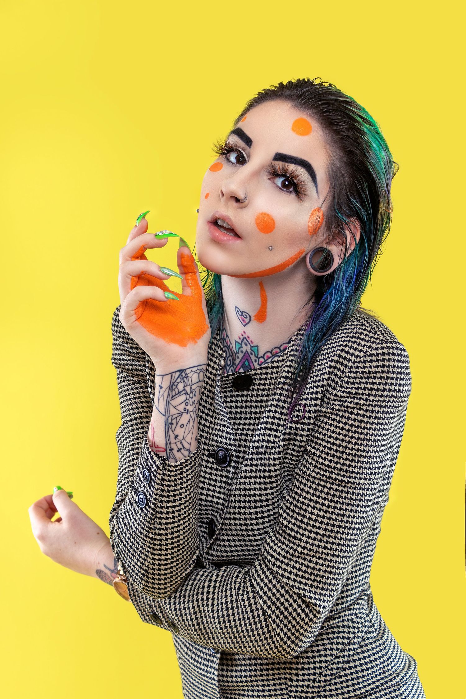 Creative portrait series with teal hair and orange dots against vibrant yellow background showing playful expressions.