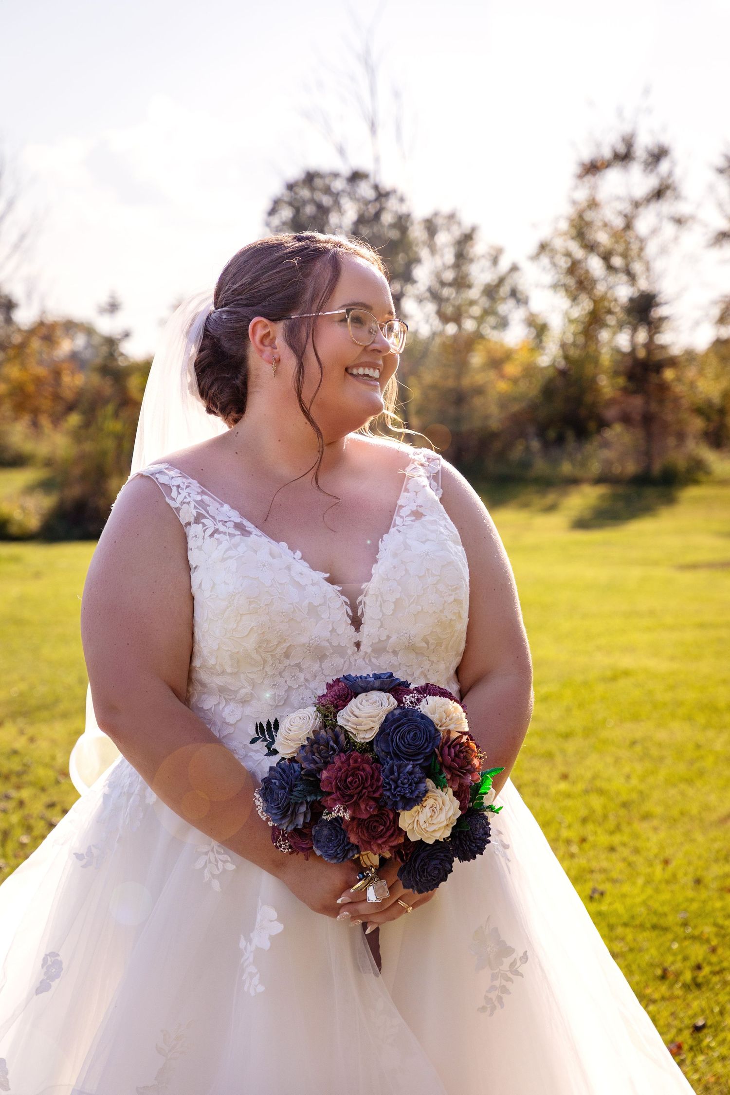 Close-up shots of a bridal bouquet with blue and burgundy flowers against a sunny outdoor background.