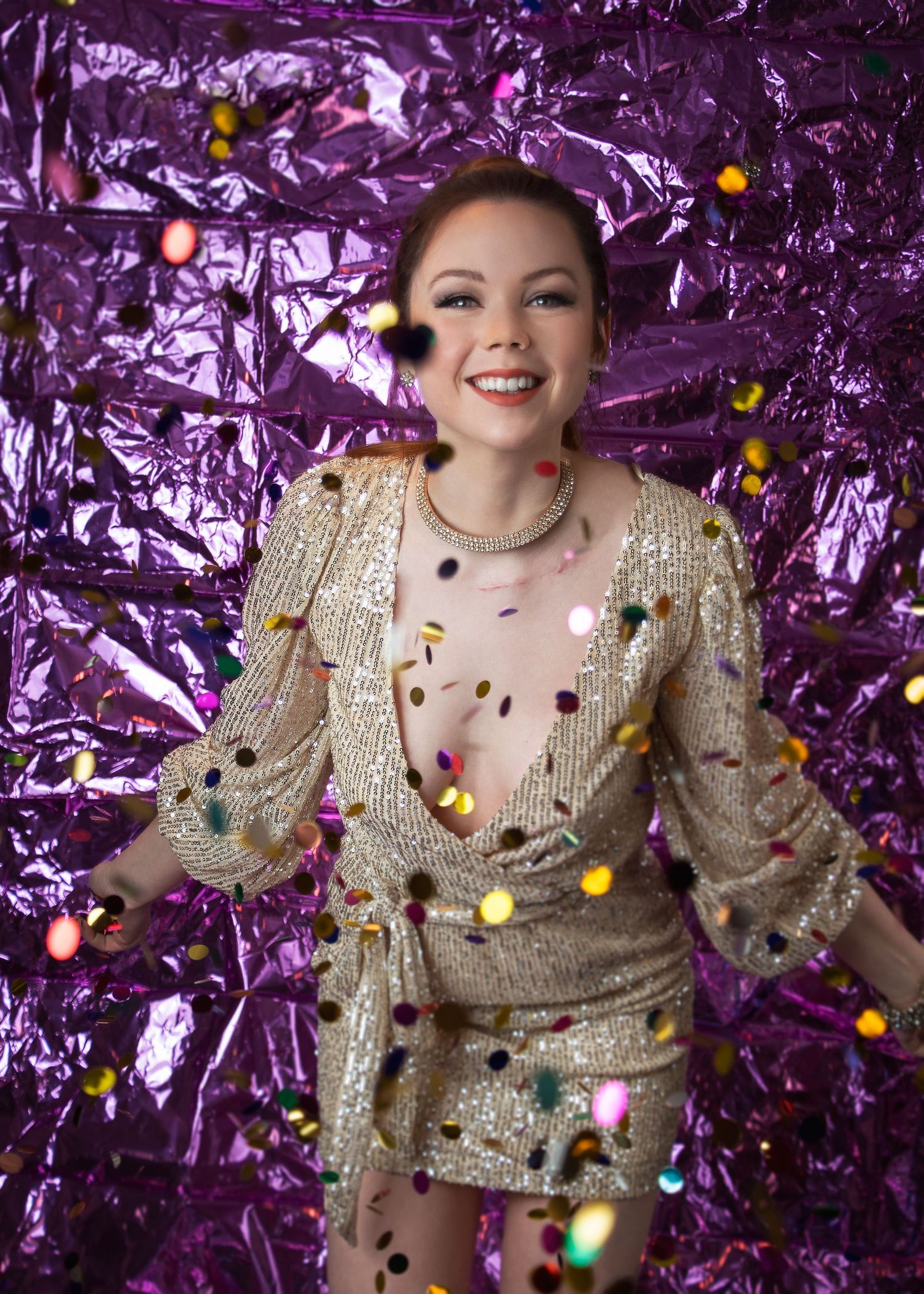 Festive portrait series in gold sequin dress with purple metallic backdrop and falling confetti.