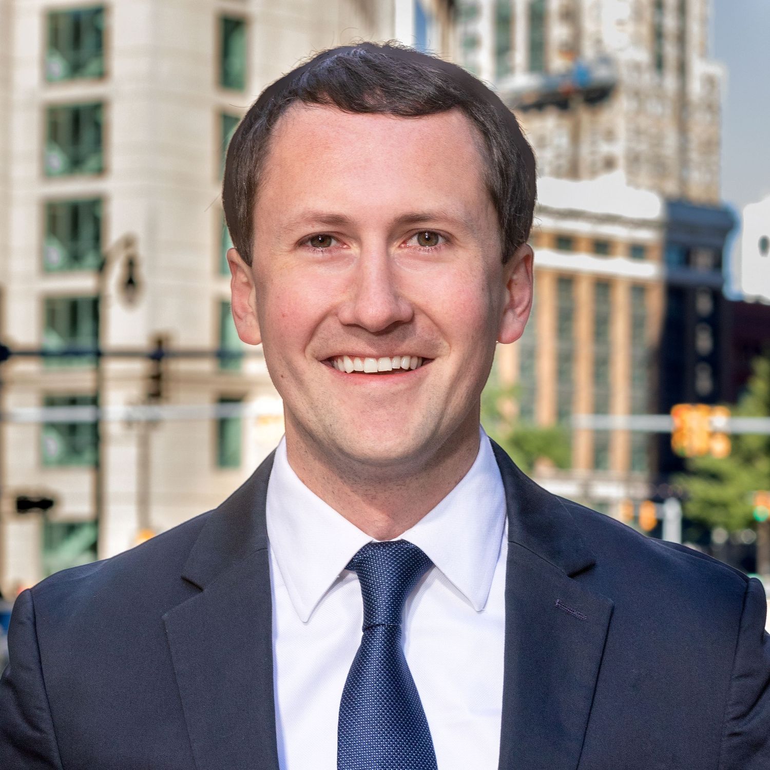 Professional headshots of businessman in navy suit and tie.
