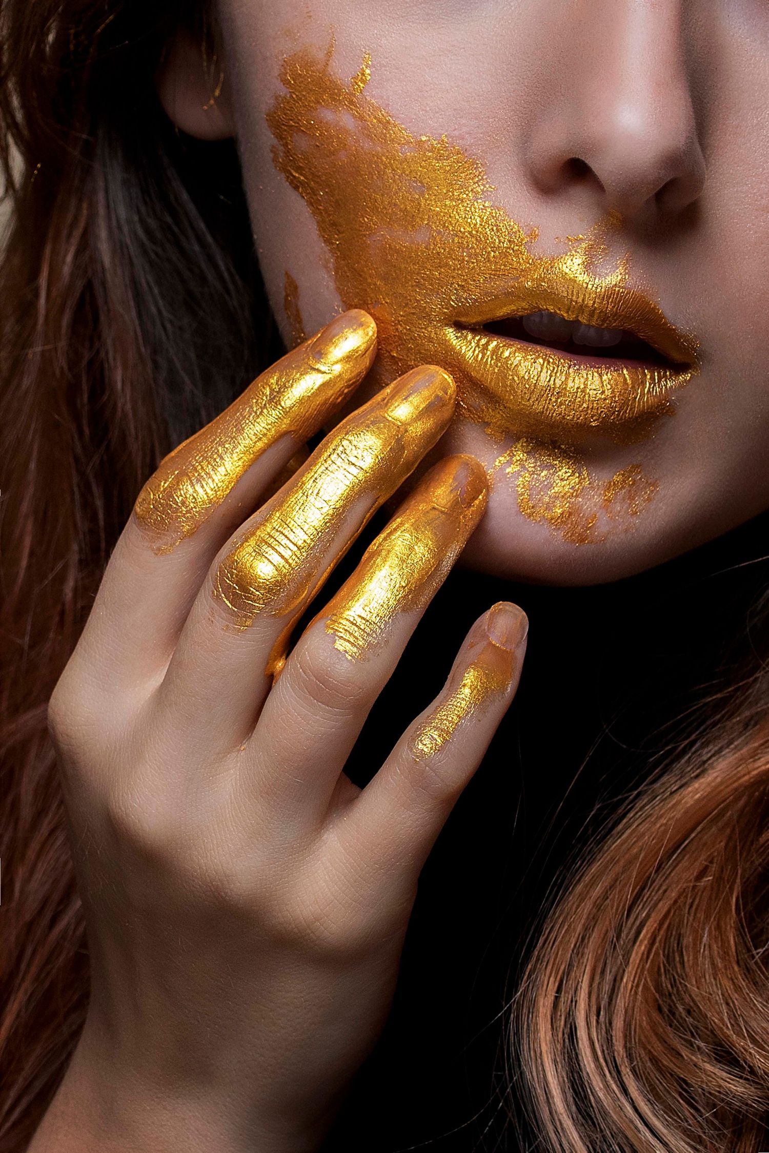 Close-up beauty shots with shimmering gold makeup and fingers near lips.