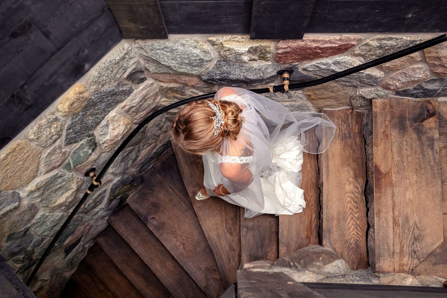 Wedding photos captured in a rustic wooden setting with dramatic lighting.