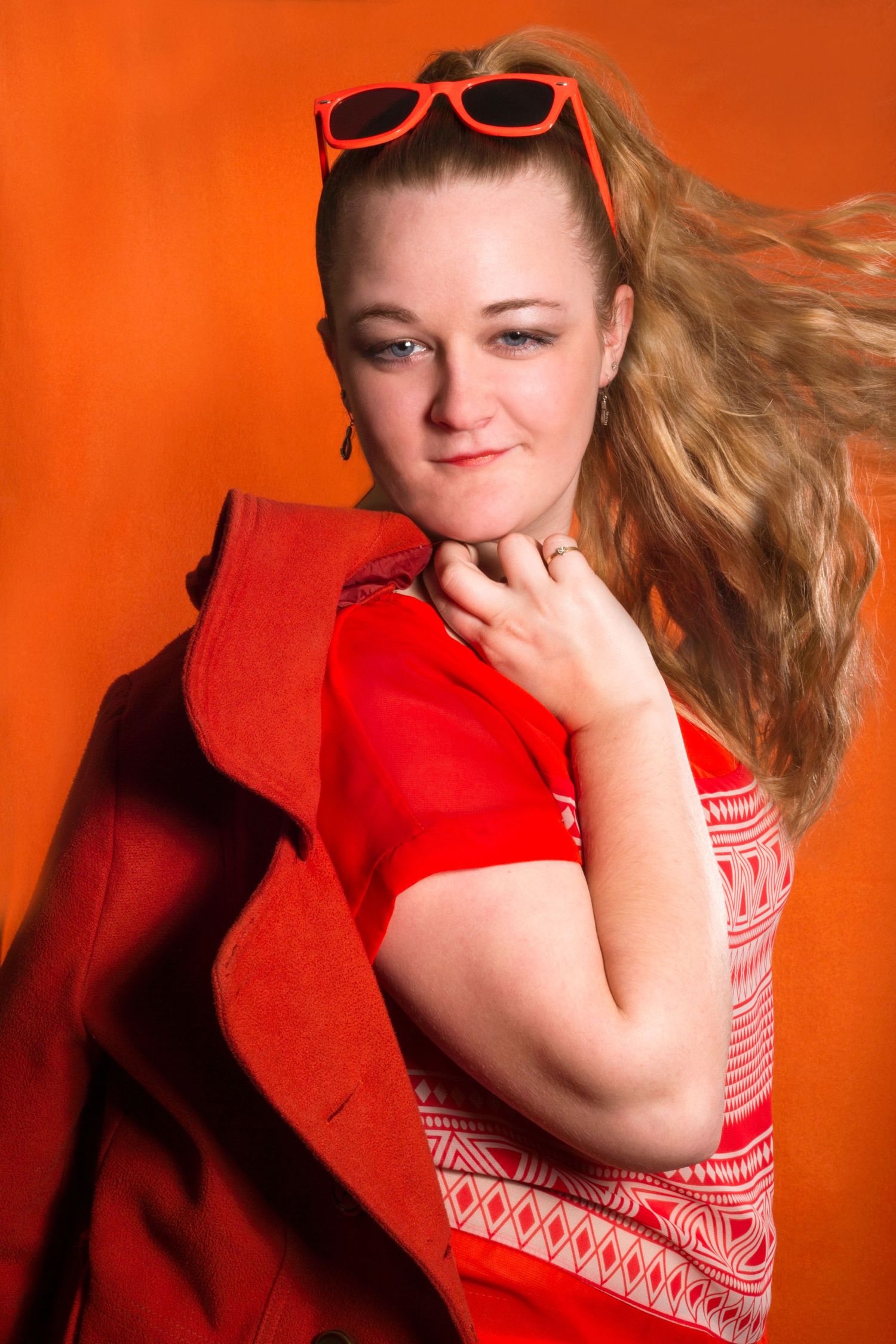 A series of photos with a bright orange background and red clothing.