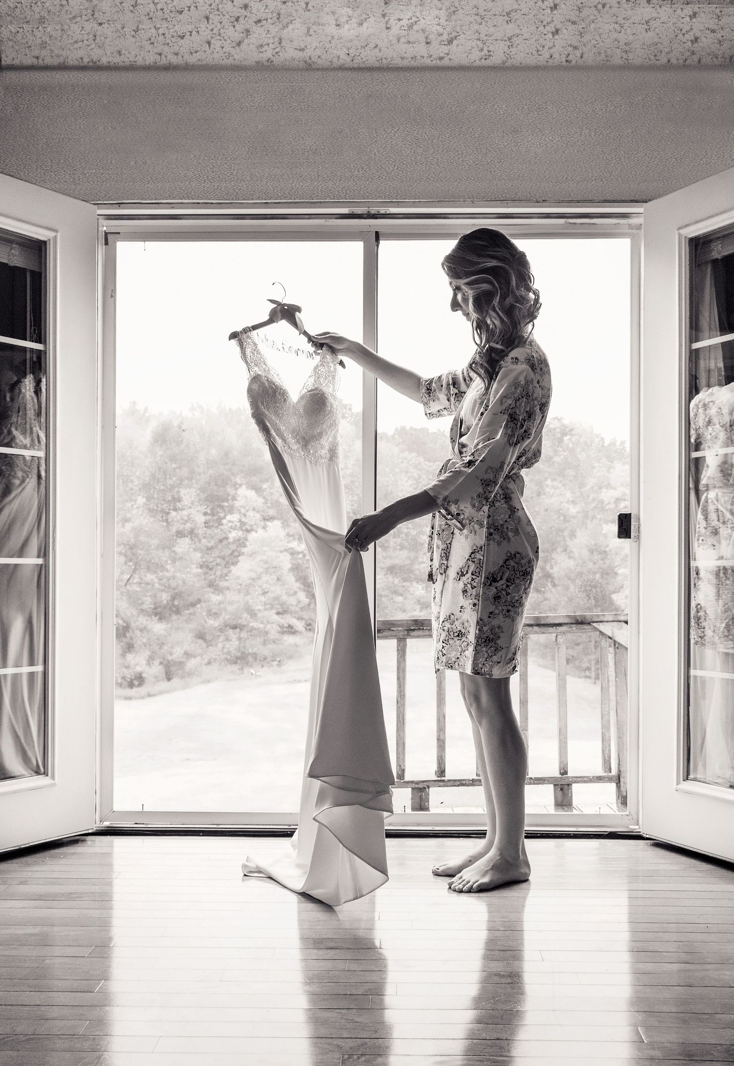 Black and white sequence of getting ready moments in a bright room with large windows.