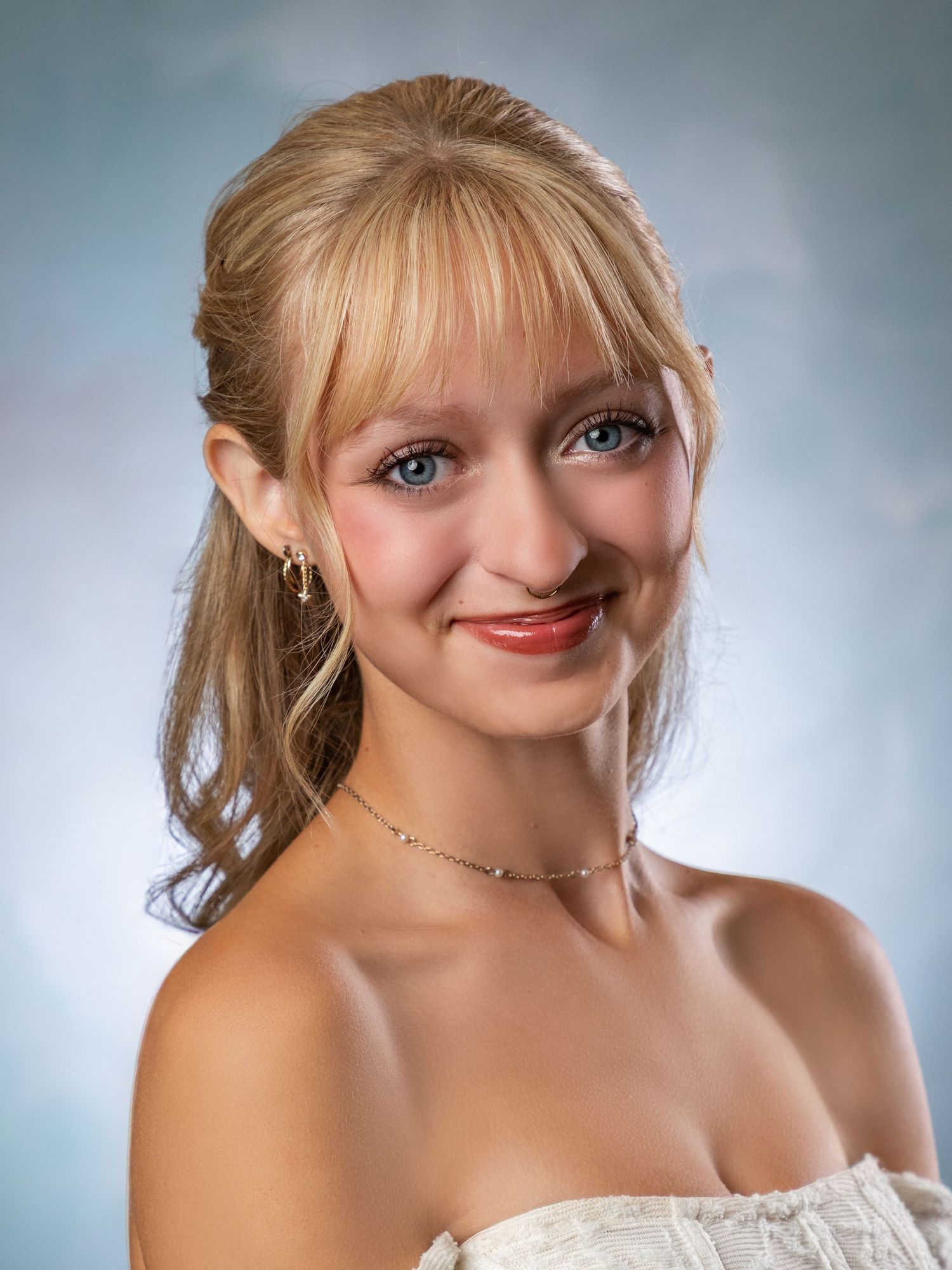 Portrait series showing joyful expressions and blonde hair against a soft blue backdrop.