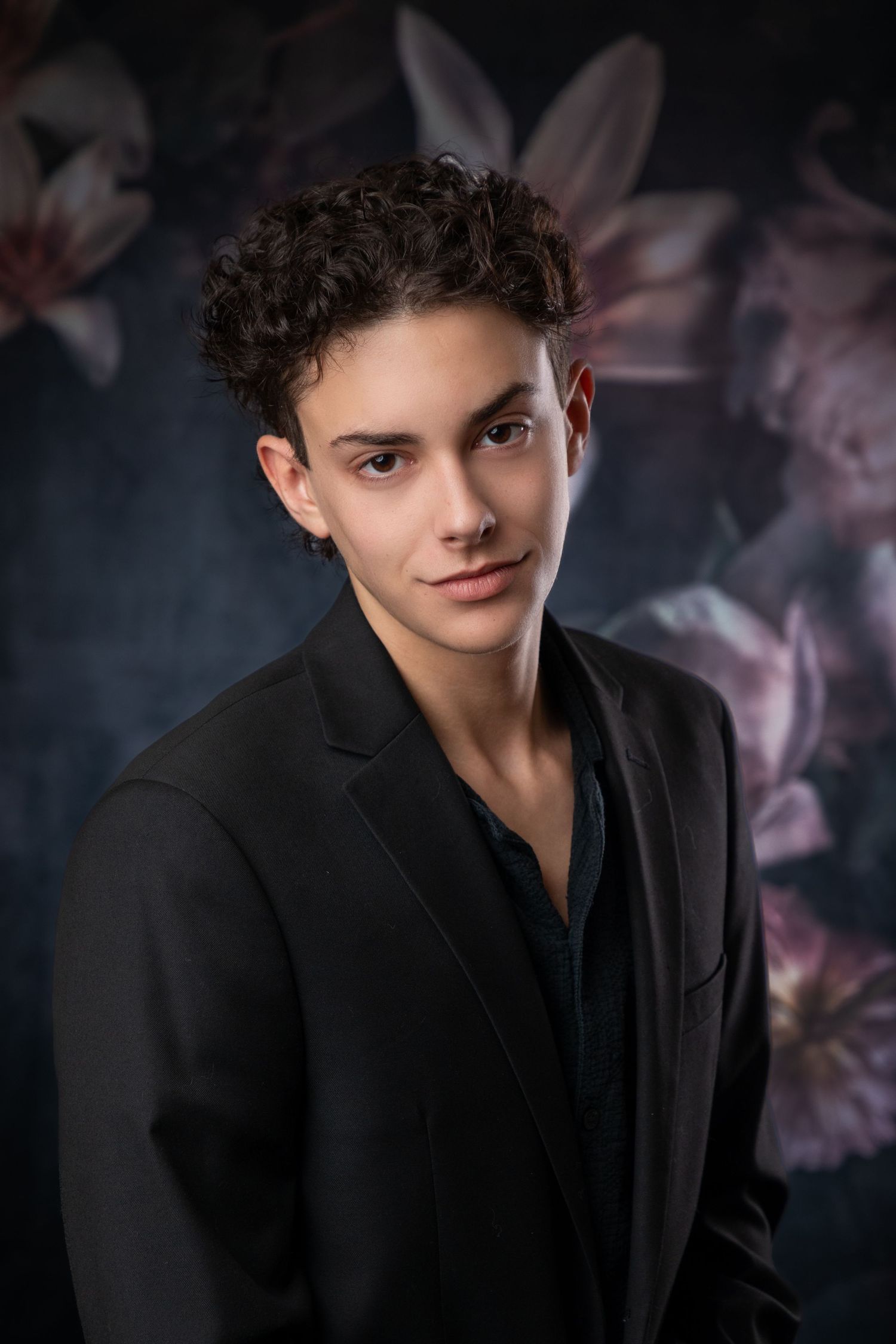 Dramatic portrait series showing someone in black attire against dark artistic background.