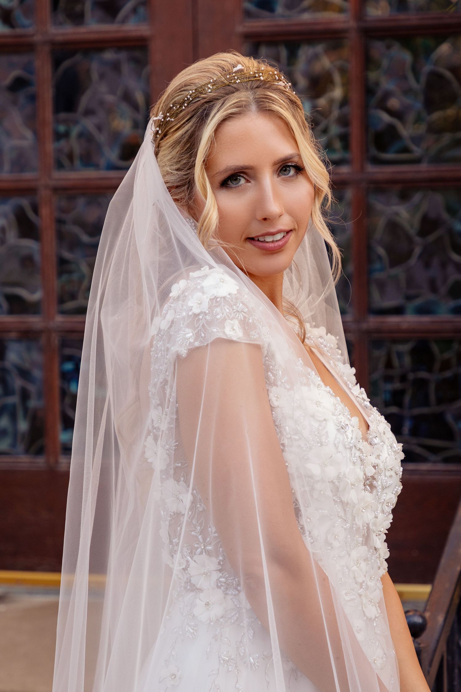 Close-up details of a white lace wedding dress with delicate veil.