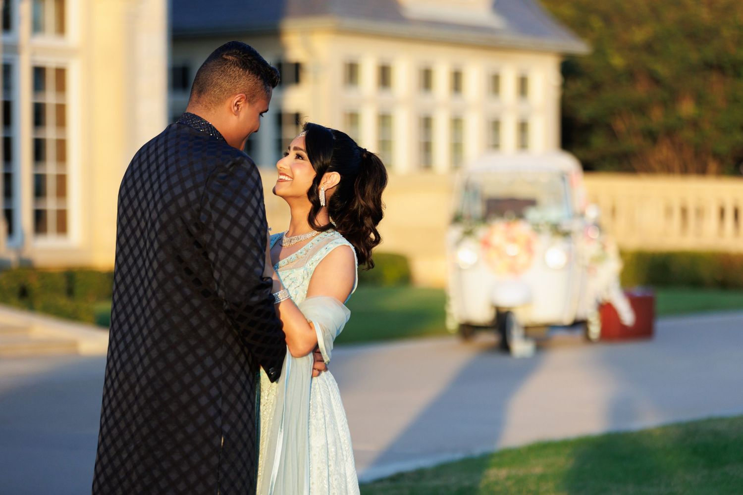 Bride and groom in front of The Olana and a decorated tuk-tuk for their wedding day on the lawn of The Olana