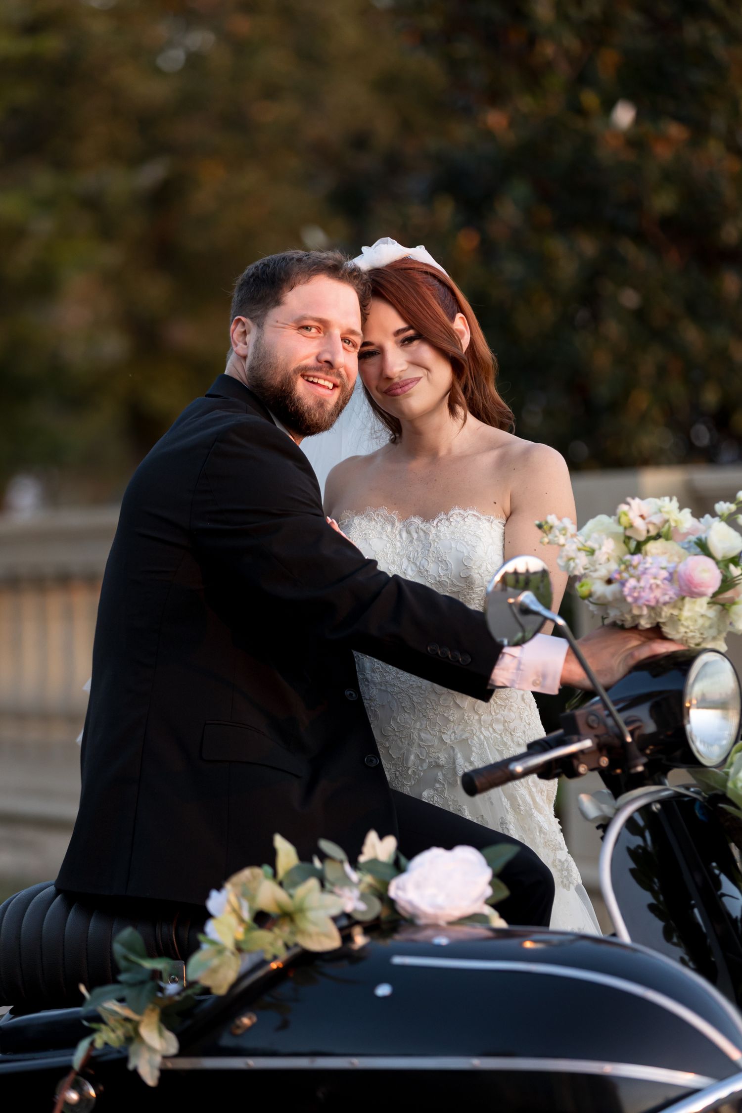 bride and groom on black vintage vespa