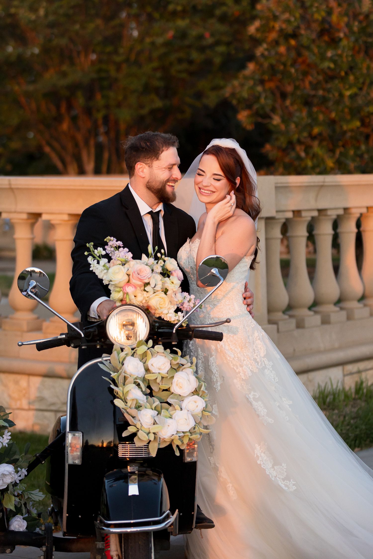 bride and groom on black vintage vespa