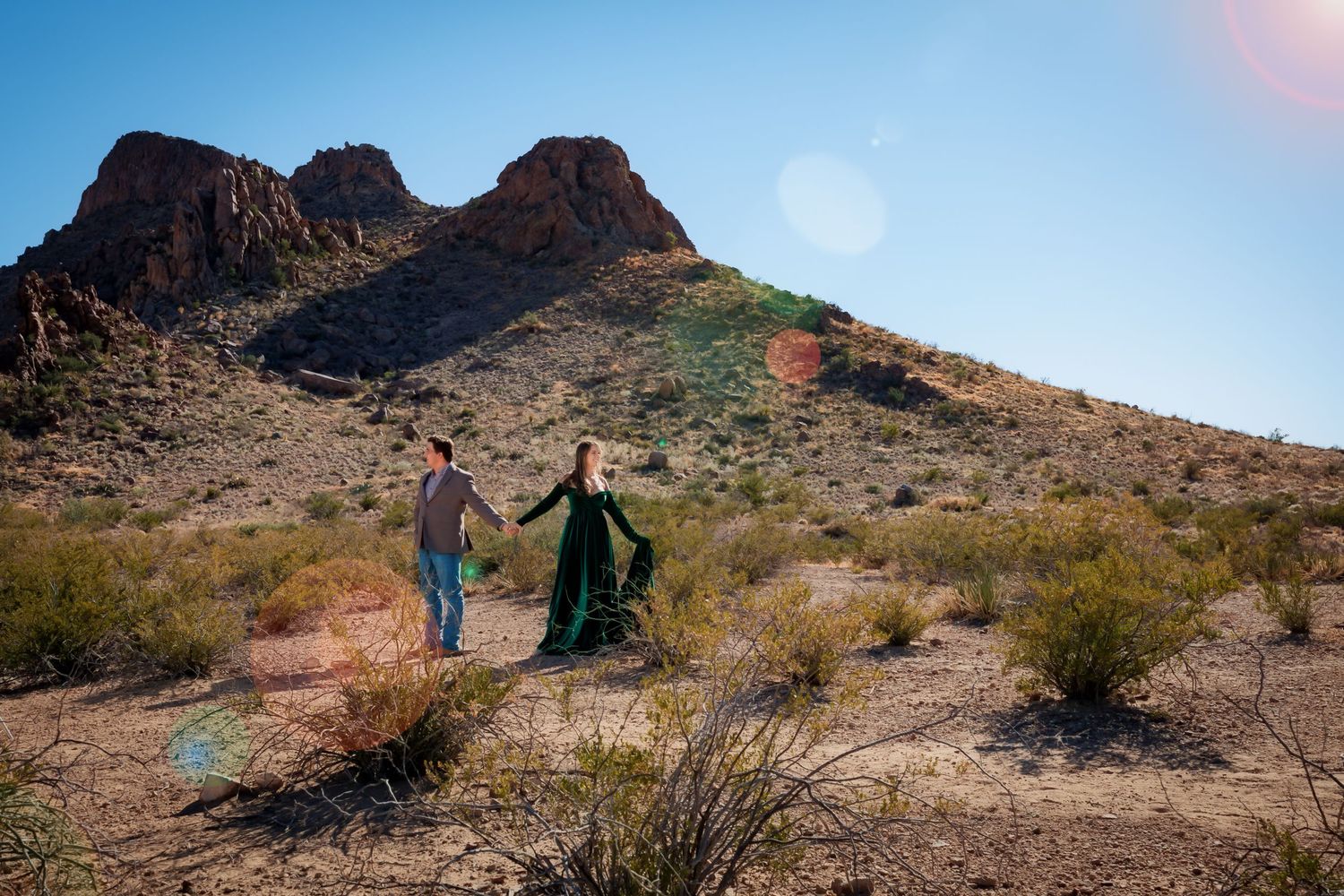 day time full sun engagement session in big bend national park with bride to be wearing emerald green velour dress