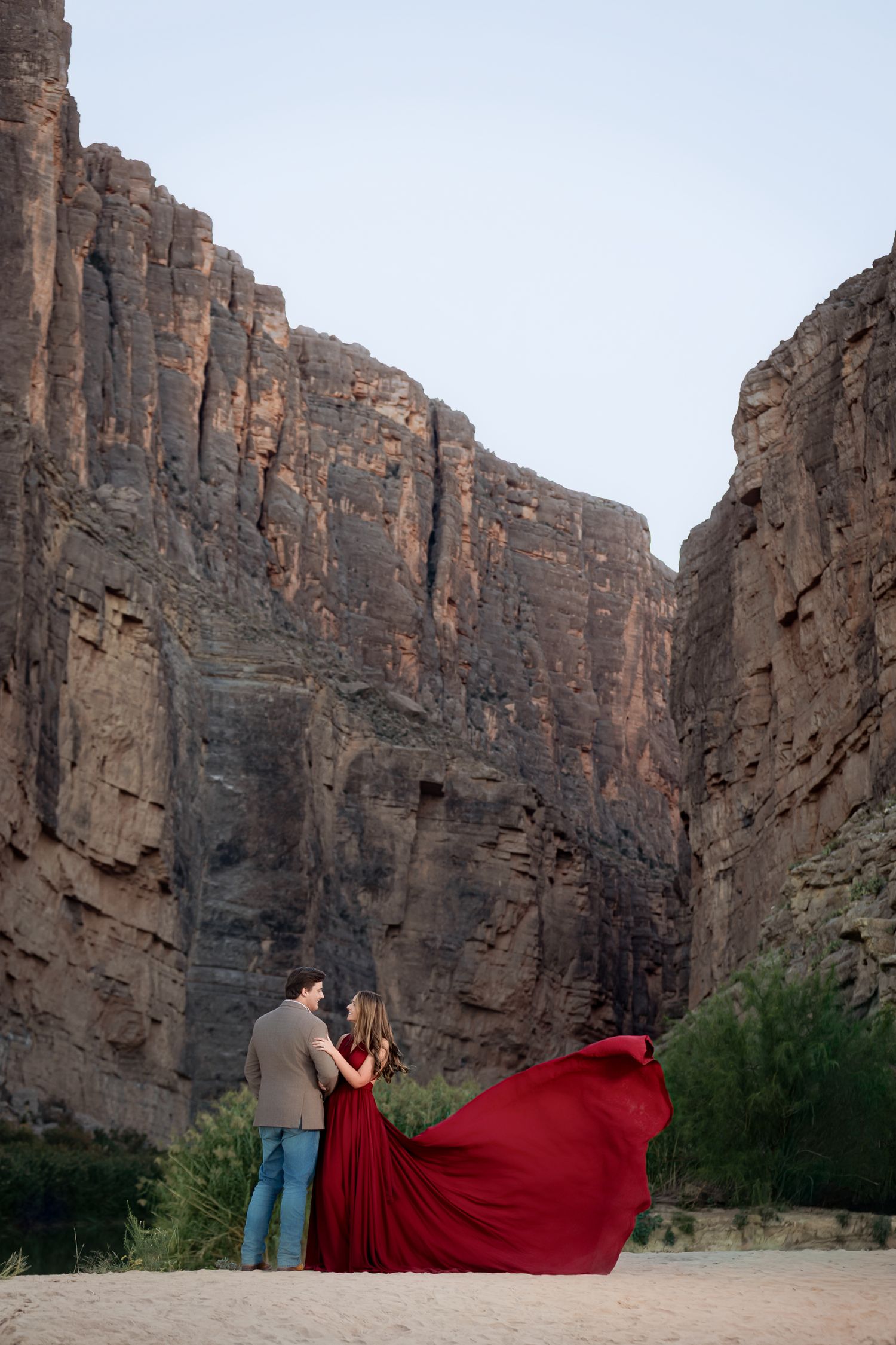 couple in front of Santa Elana canyon in red dress