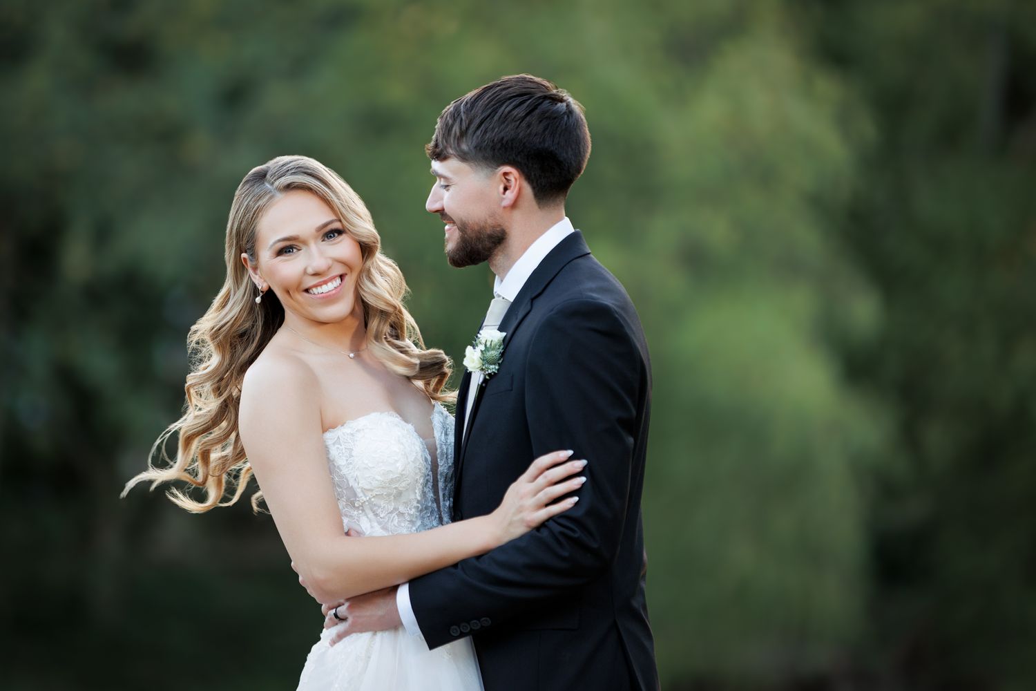 Bride and groom candid moment on the lawn of wedding venue