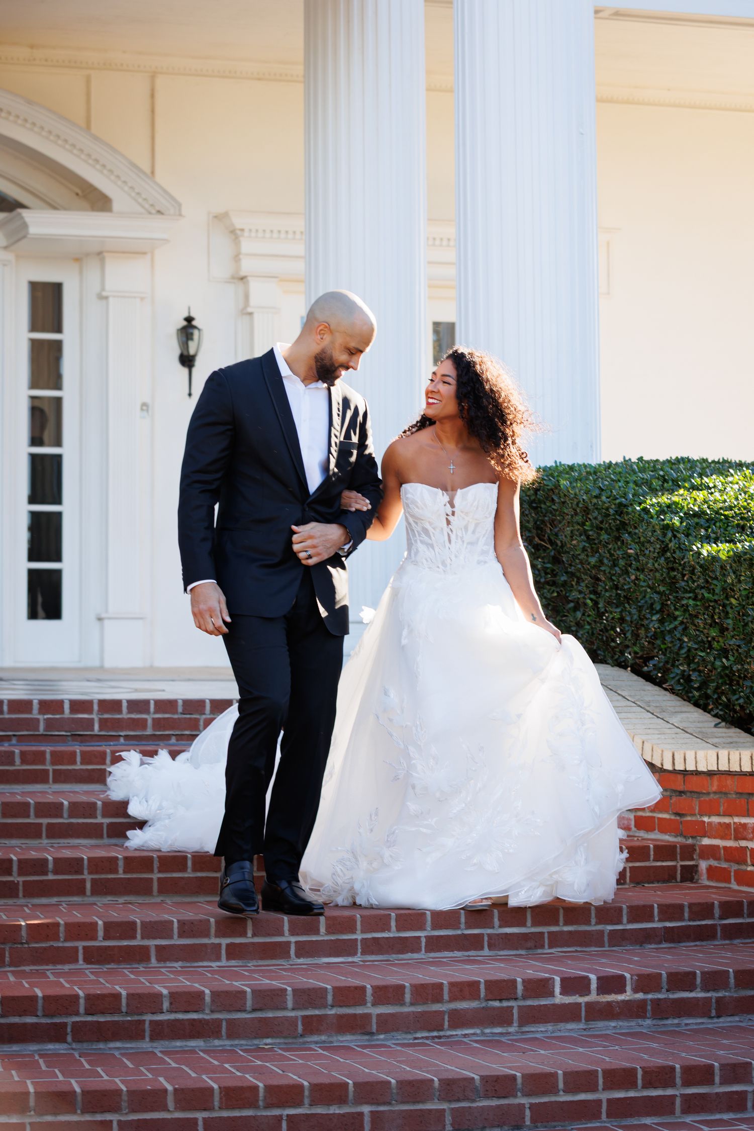 bride and groom candid moment walking down stairs at the mansion Fort Worth