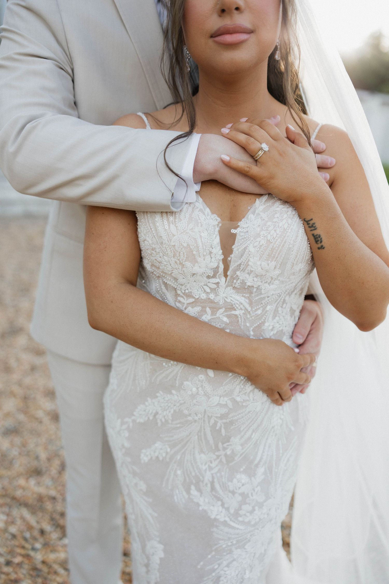 Close-up of intricate lace wedding dress details with delicate embroidery.