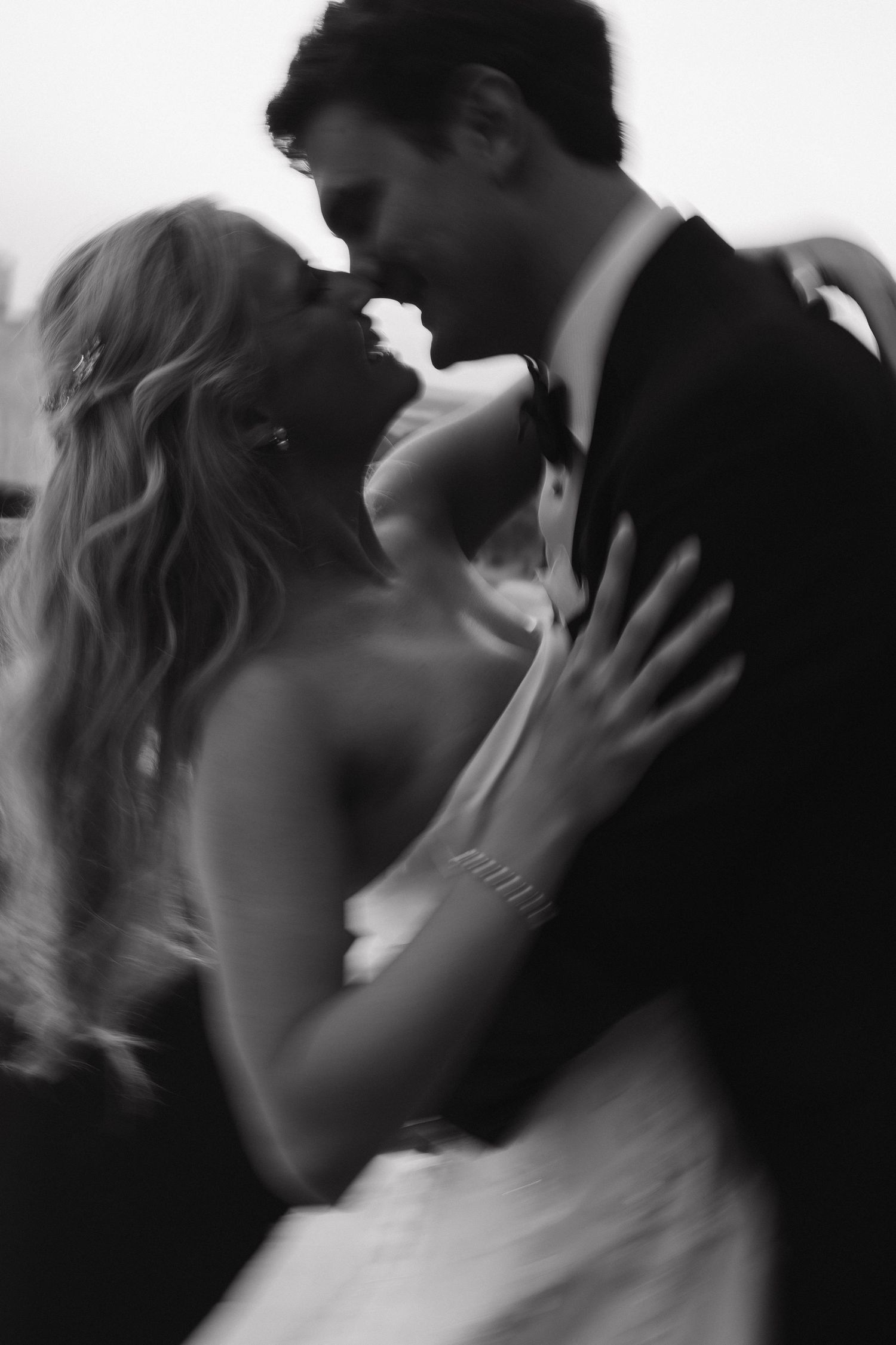 Romantic black and white photo sequence of newlyweds sharing intimate moments.