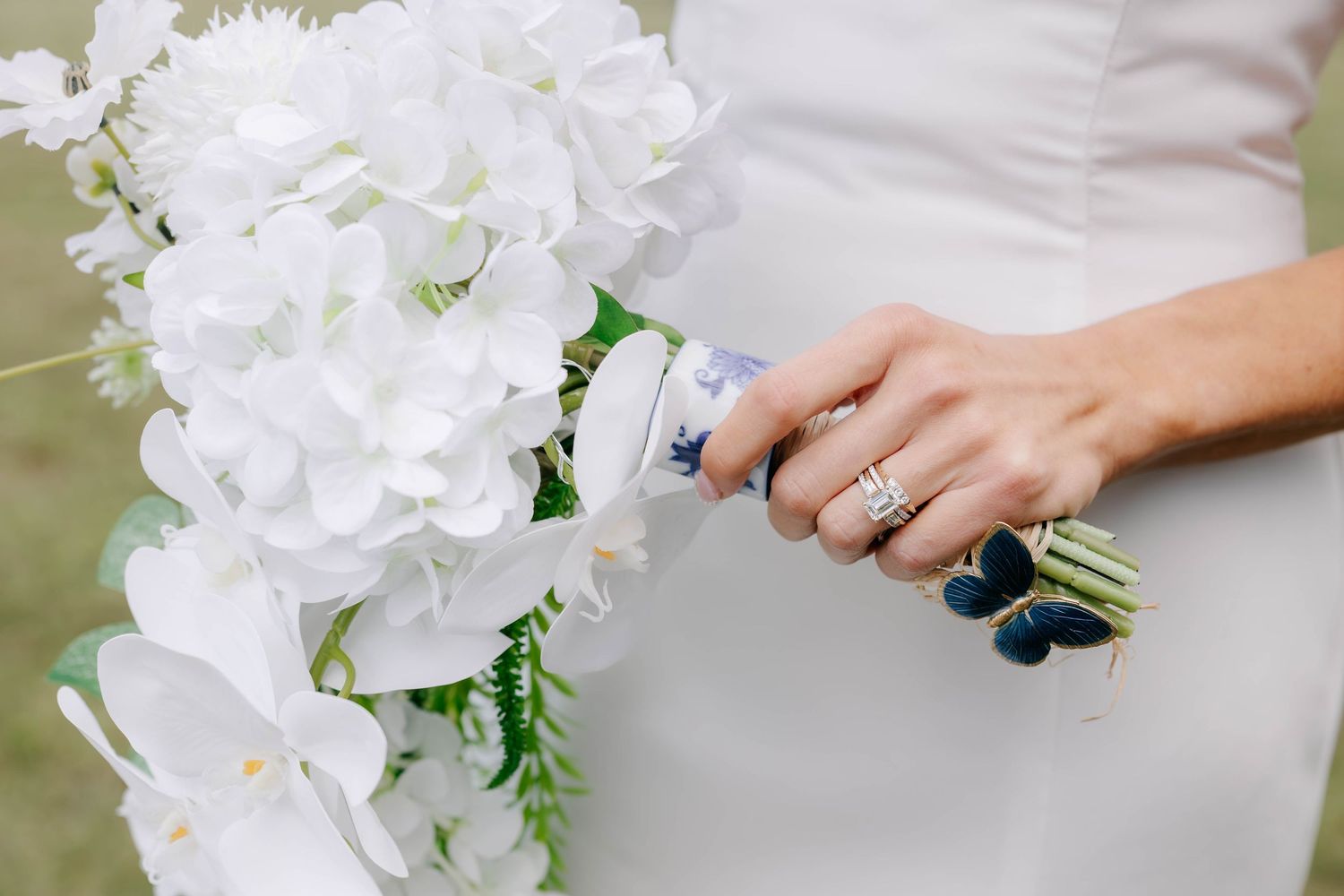Detail shots of a white orchid wedding bouquet with green accents.