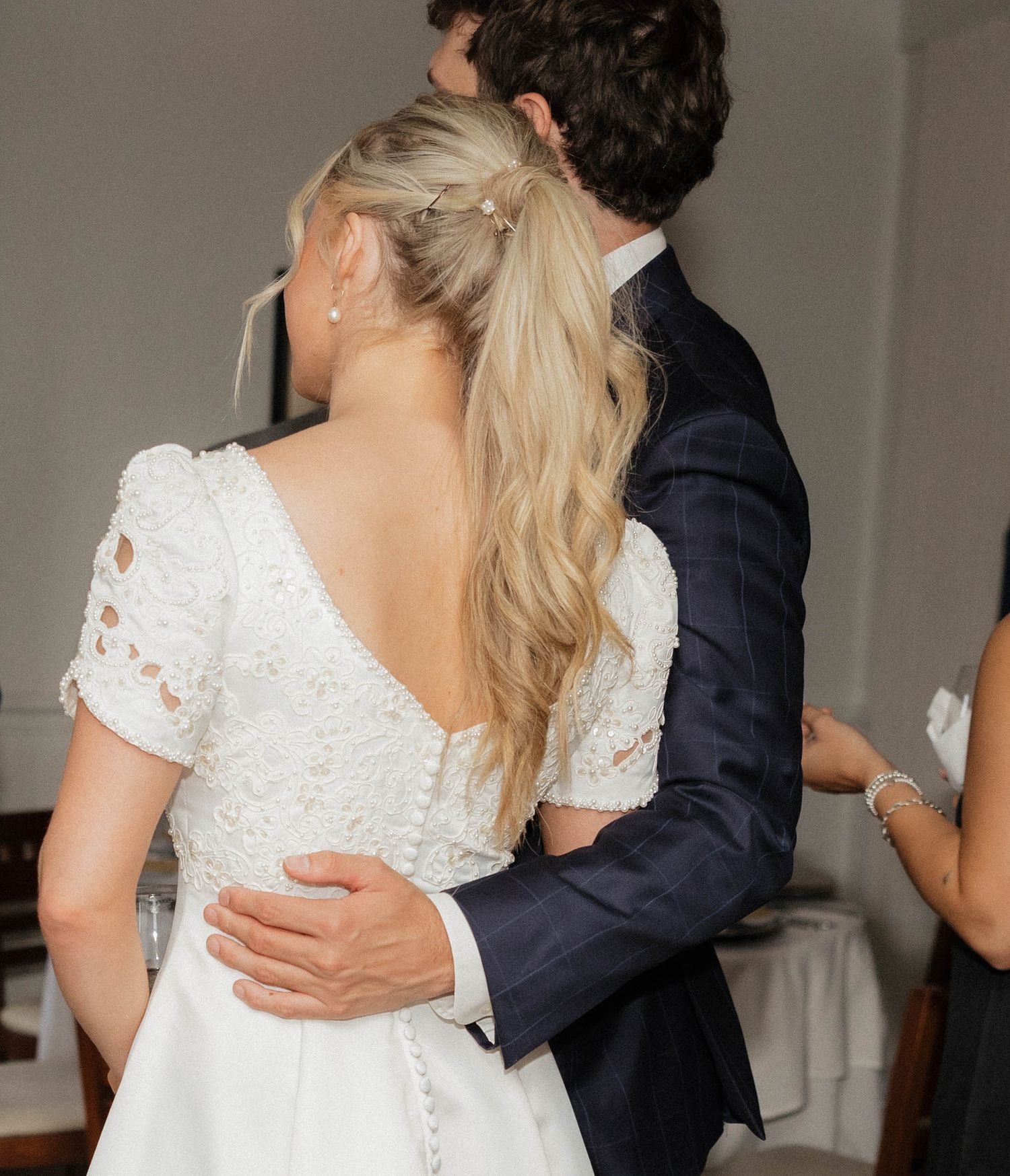 A couple embraces during a romantic dance at their wedding reception.