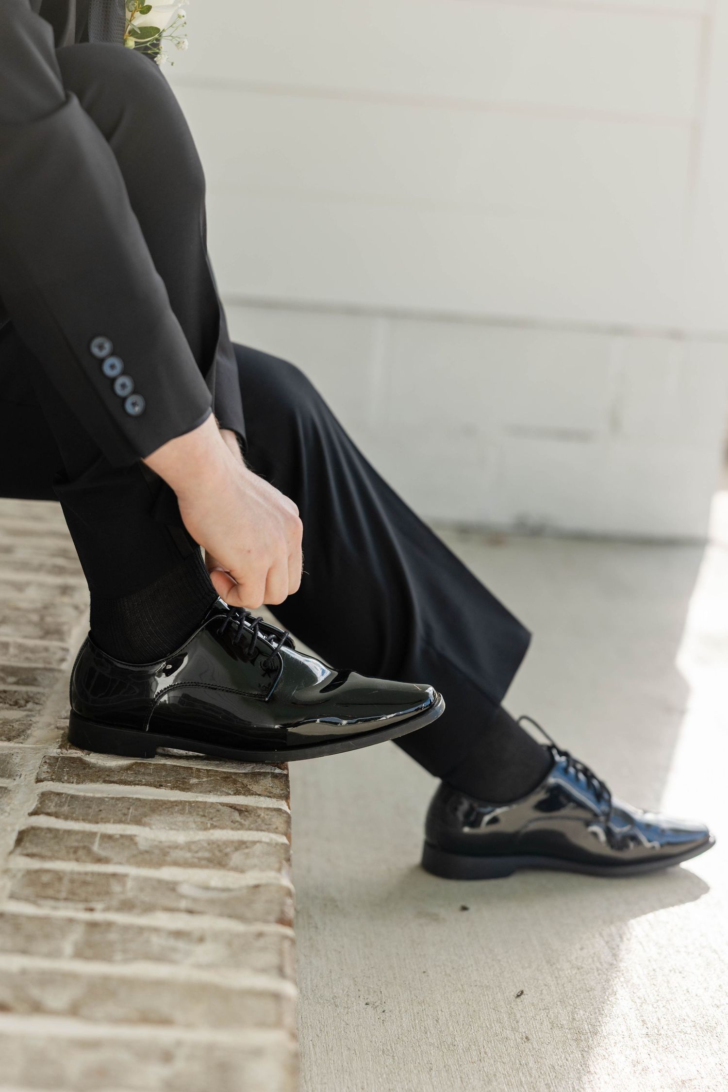 Detail shot of formal black dress shoes worn by groomsmen.