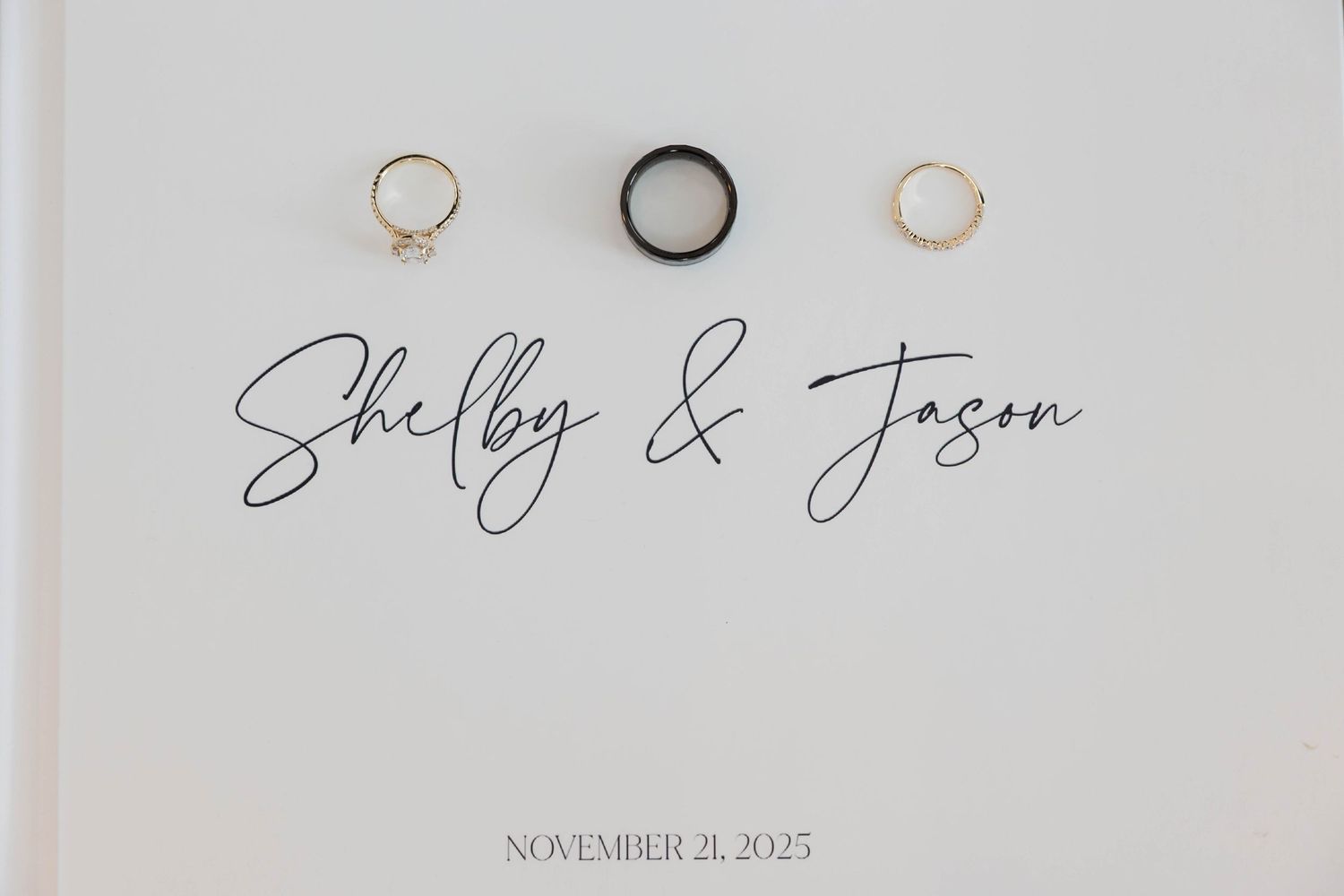 Wedding rings photographed on white background with elegant script text.