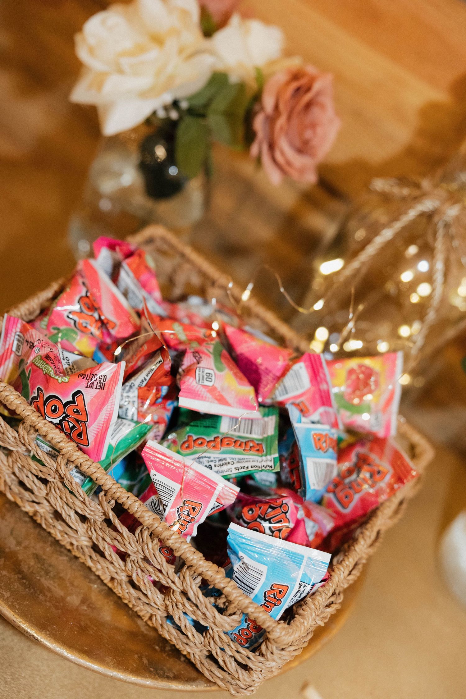 Woven basket filled with colorful candy favors at a wedding reception.