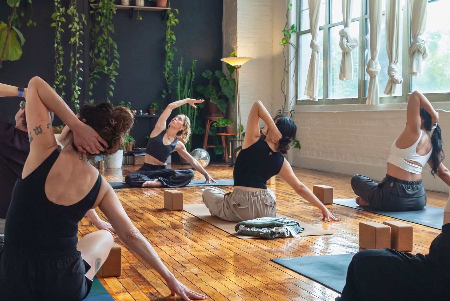 Group yoga class practicing together in a yoga studio