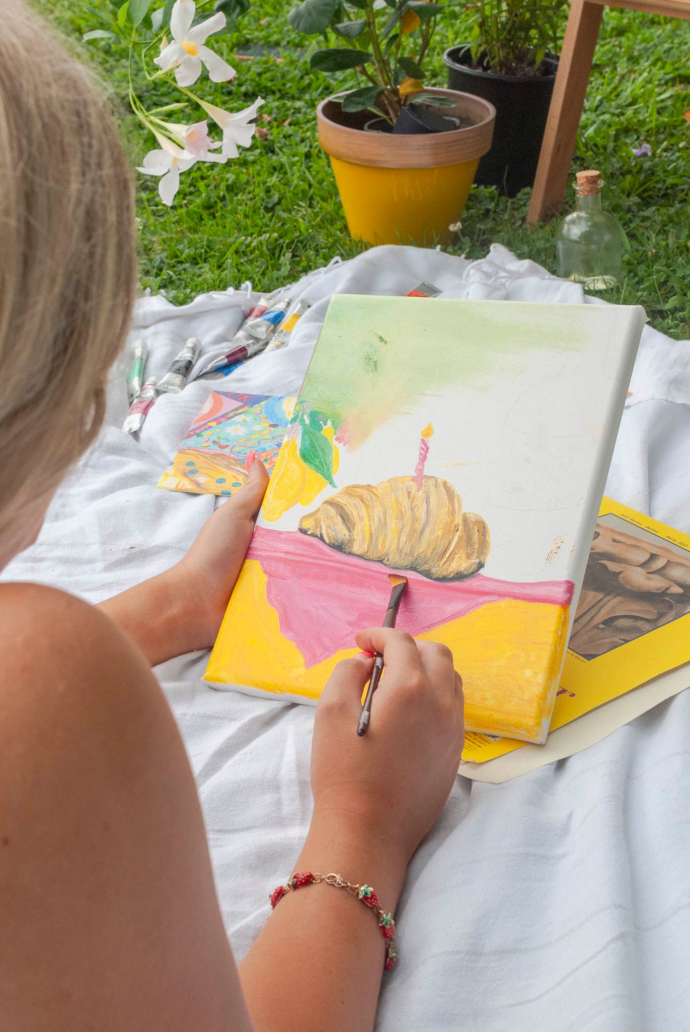 Artist painting outdoors during a branding photography session