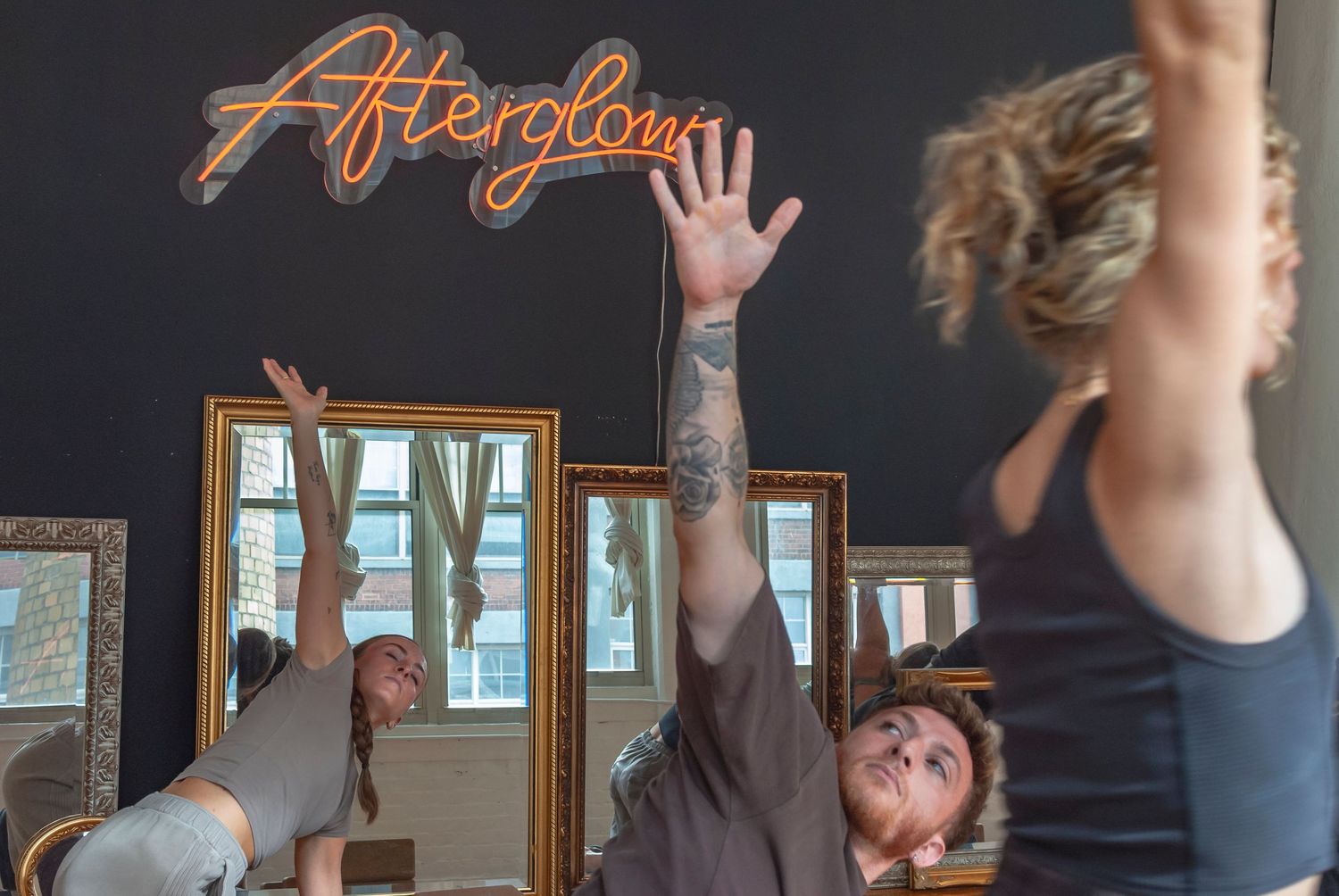 Group yoga class practicing together in a yoga studio