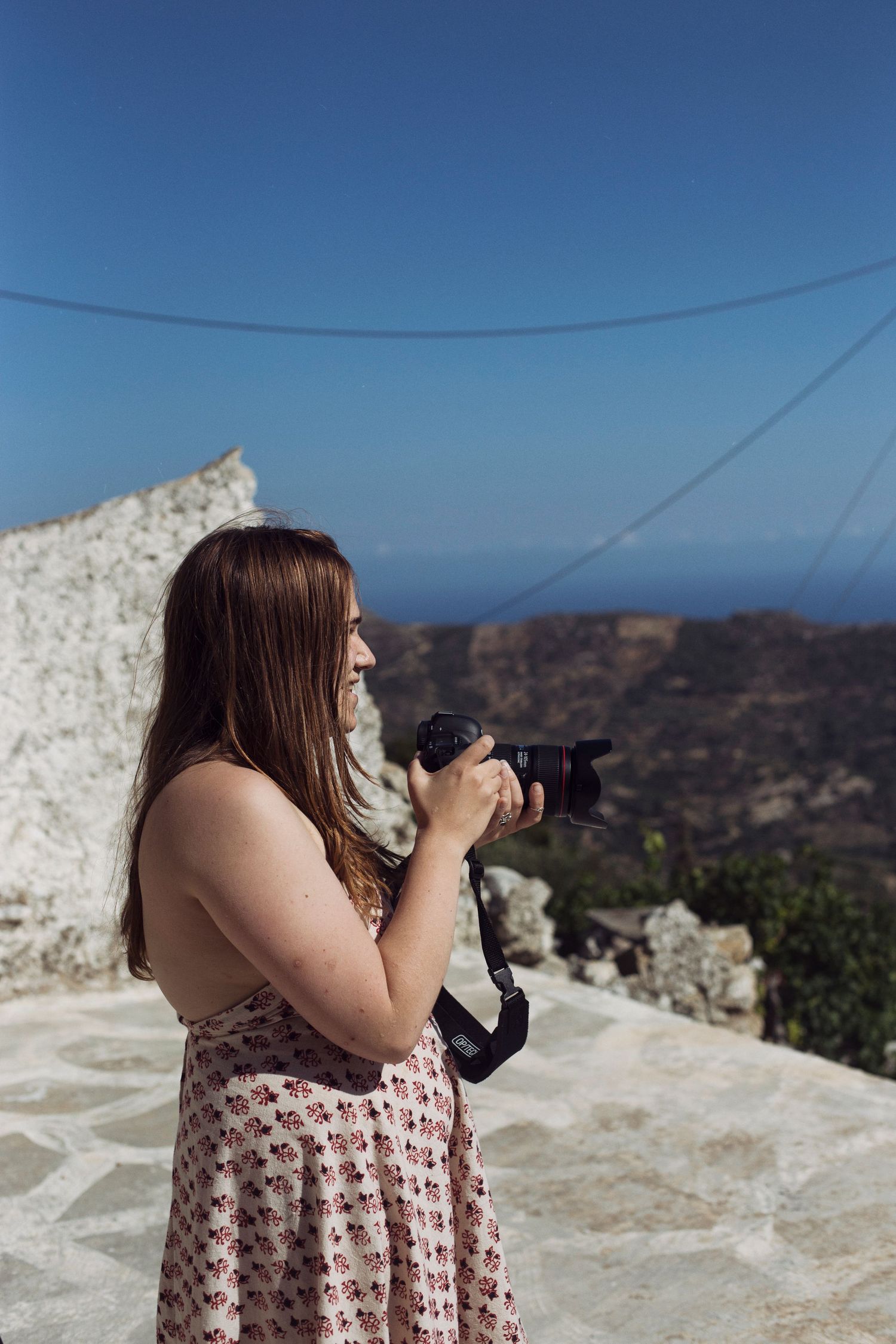 Photograph of a photographer taking a picture of the view in Crete, Greece