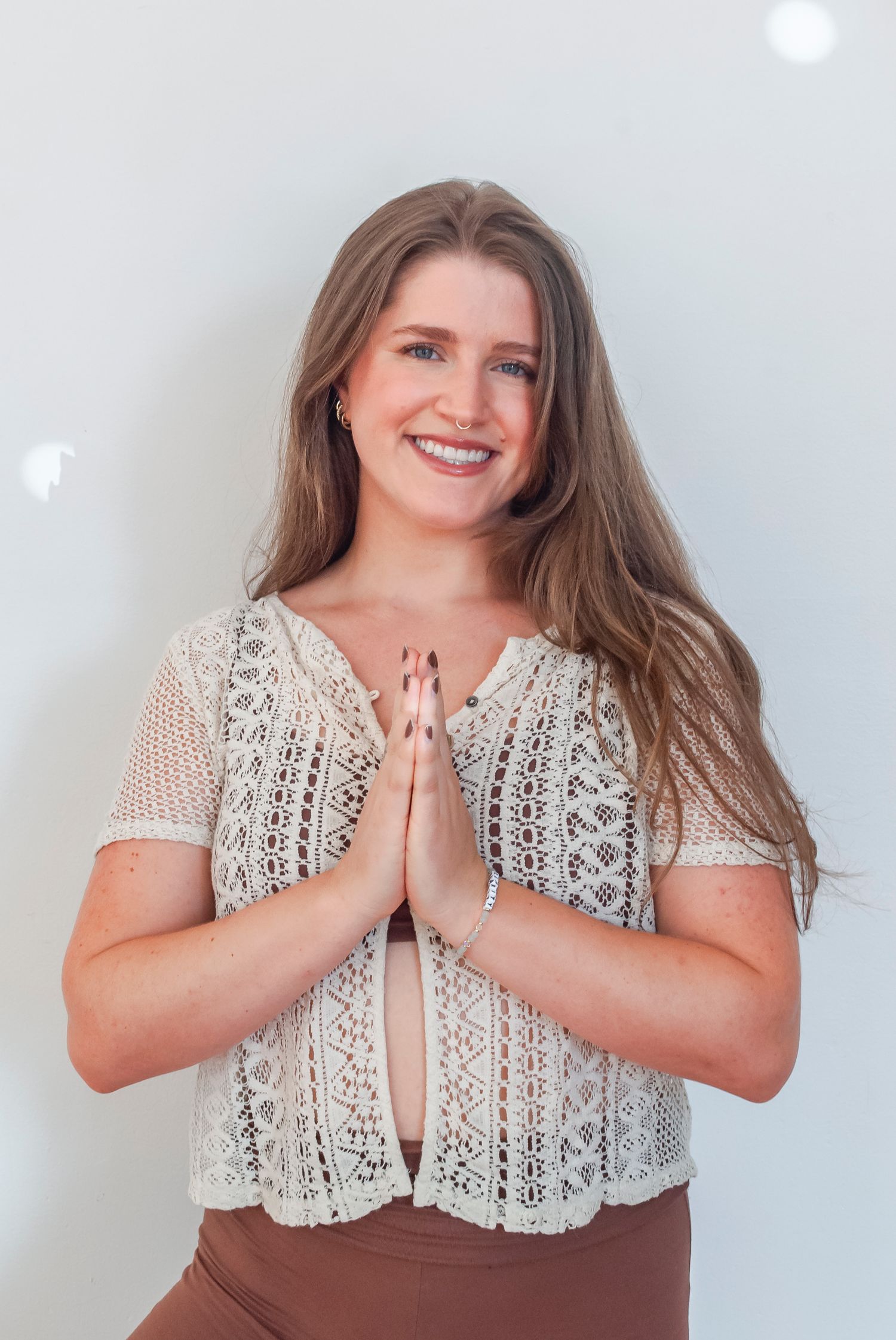 Headshot of a yoga teacher in a sun lit studio