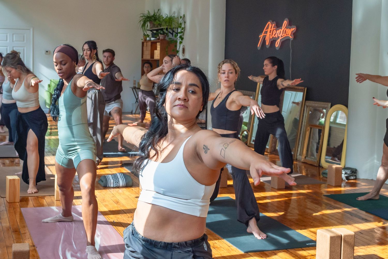 Group yoga class practicing together in a yoga studio