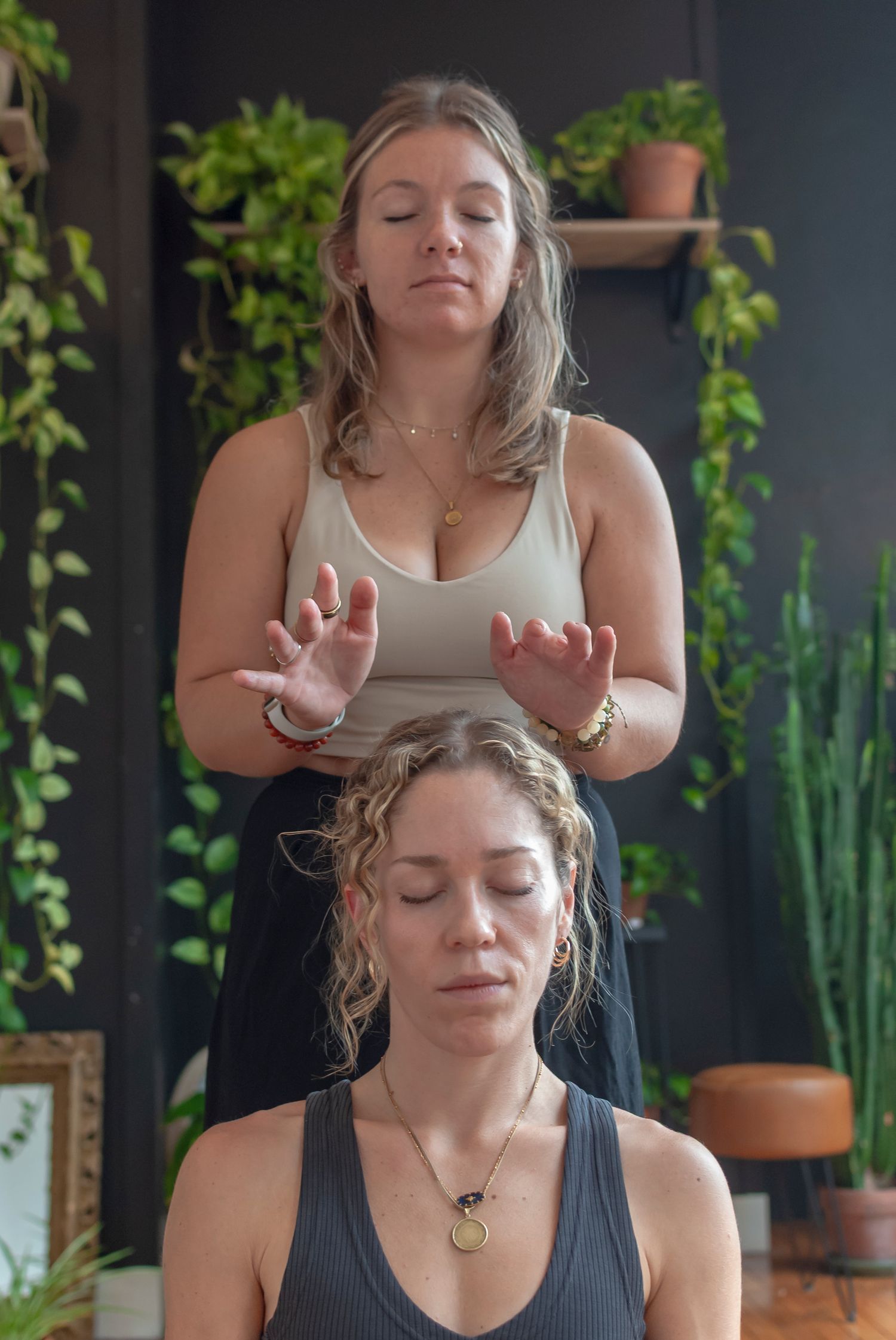 Photograph of a two women practicing yoga indoors in a yoga studio