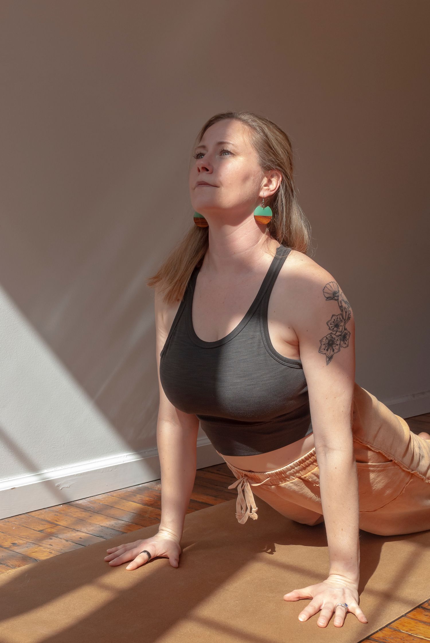 Photograph of a woman practicing yoga indoors in natural light