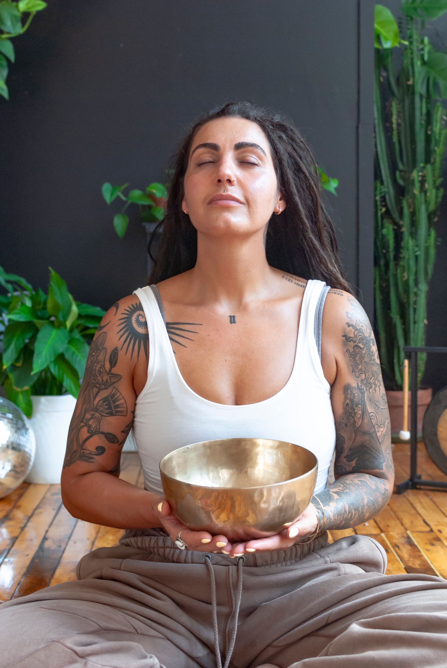Portrait of a yoga teacher with sound bowl in a studio